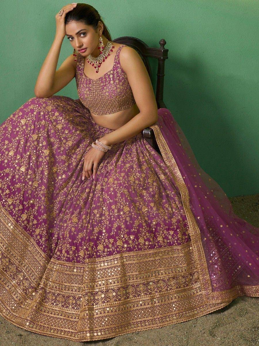 Purple and gold embroidered lehenga choli with heavy border, perfect for Indian weddings and festive occasions