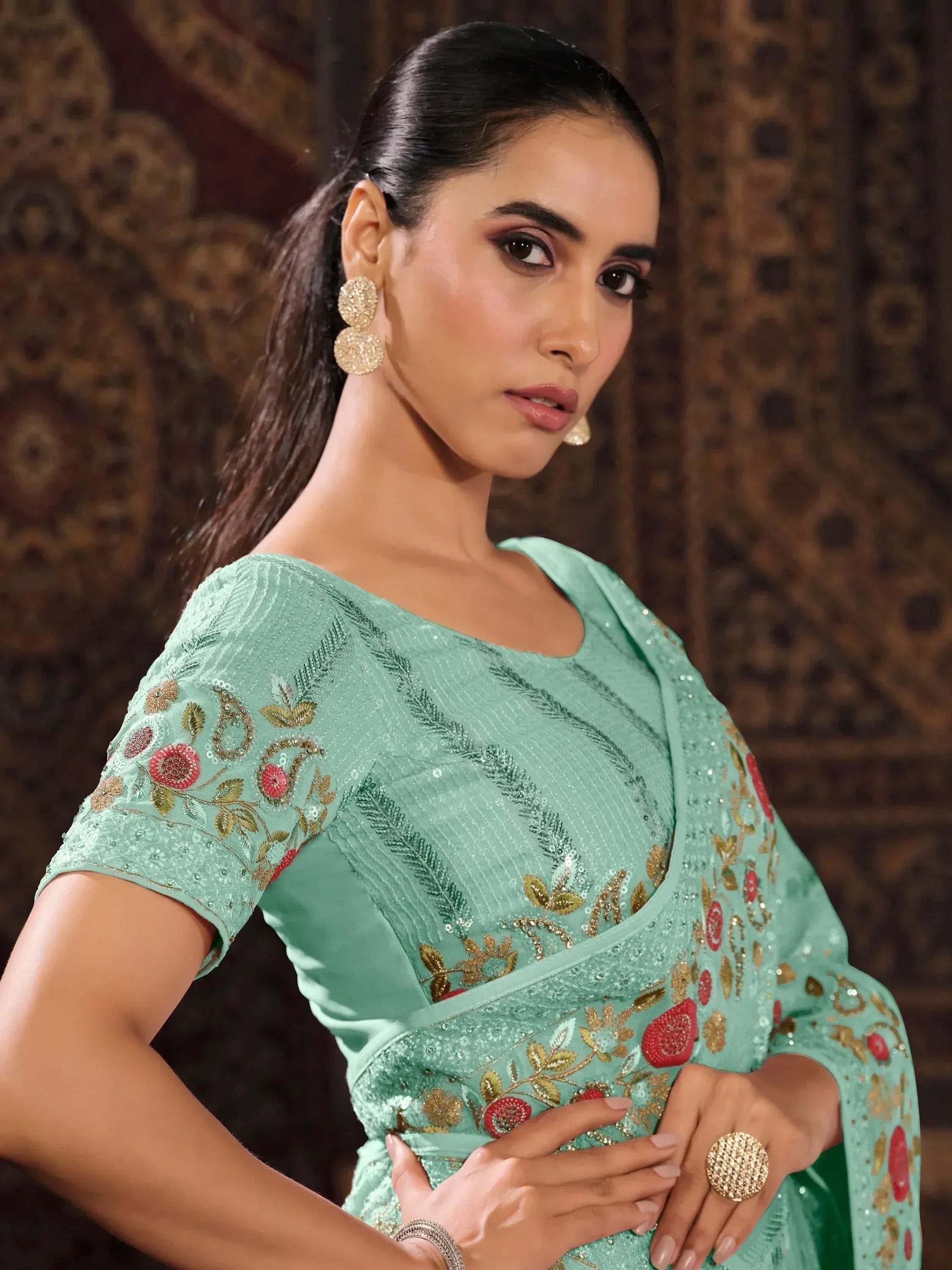 Mint green designer saree with floral embroidery and gold detailing, perfect for ethnic occasions