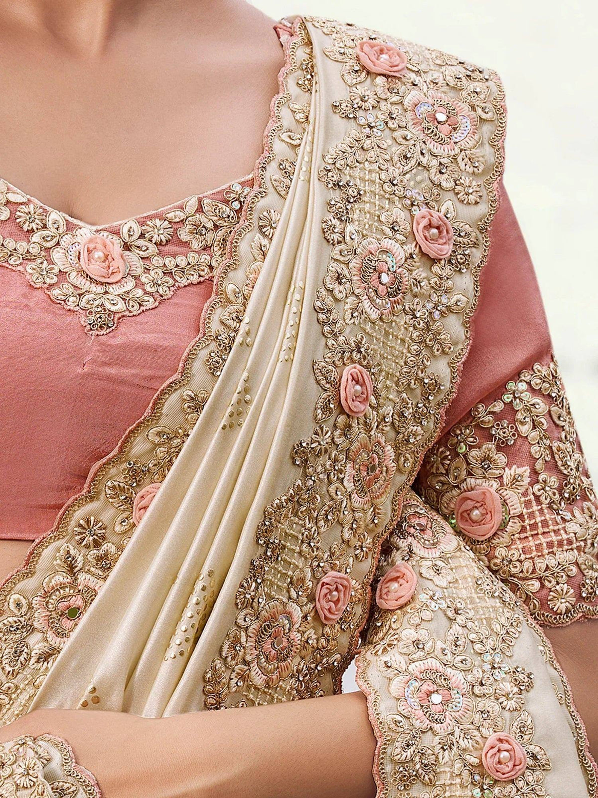 Pink and gold embroidered saree with floral appliqués and pearl detailing, perfect for Indian ethnic wear occasions.