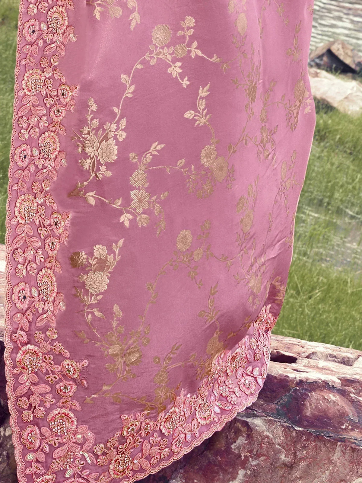 Pink ethnic gown with gold floral embroidery and beaded lace border, perfect for Indian occasions