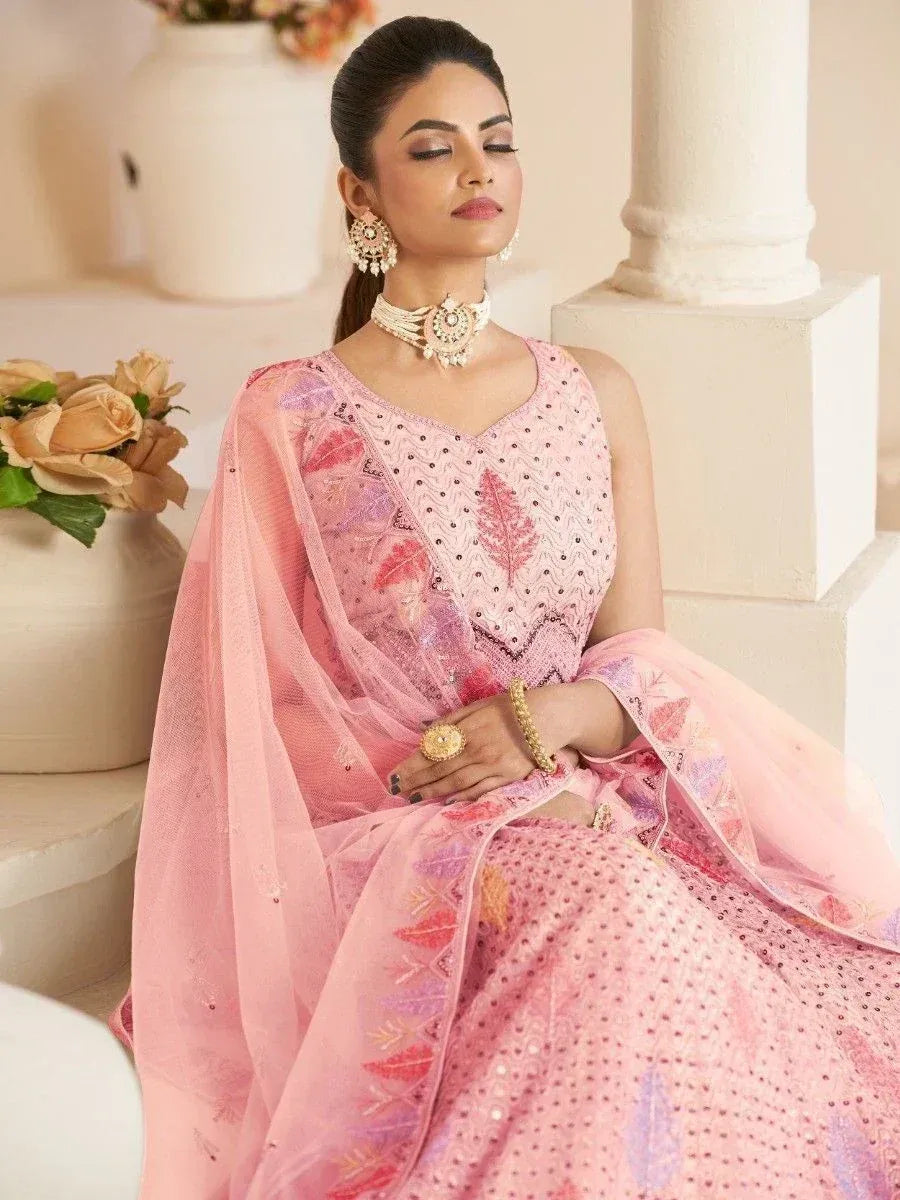 Pink embroidered ethnic gown with matching dupatta, perfect for Indian weddings and festive occasions.