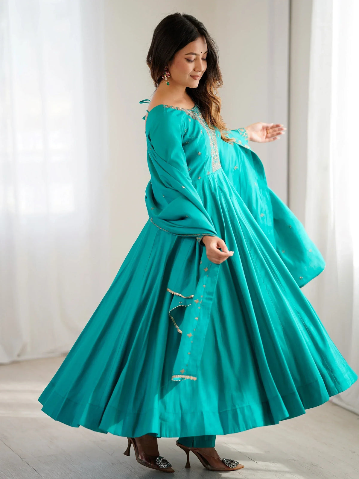 Teal ethnic gown with gold embroidery, perfect for Indian festive occasions and weddings.