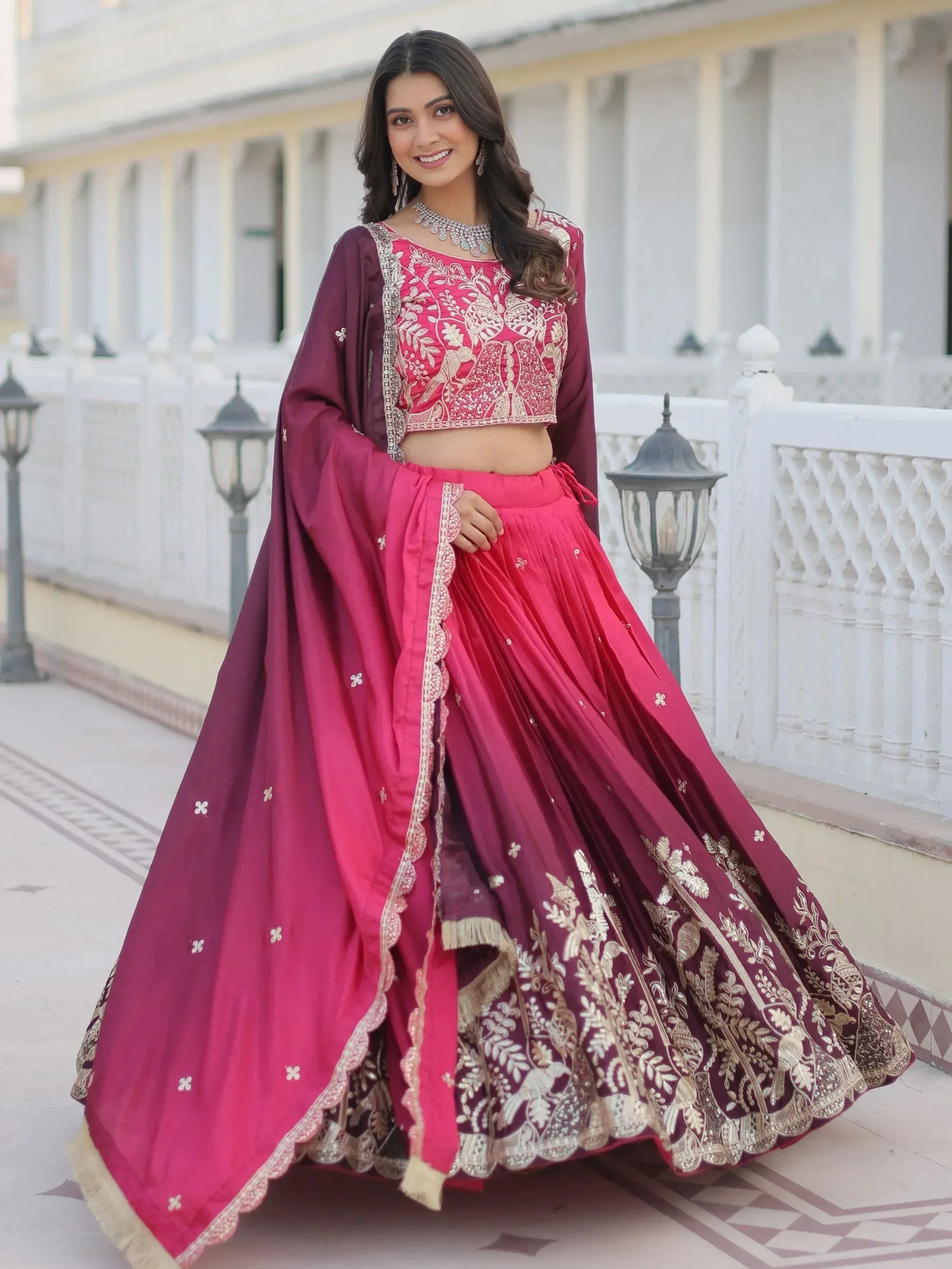 Elegant maroon and pink embroidered lehenga choli with gold detailing, perfect for Indian weddings and festive occasions.