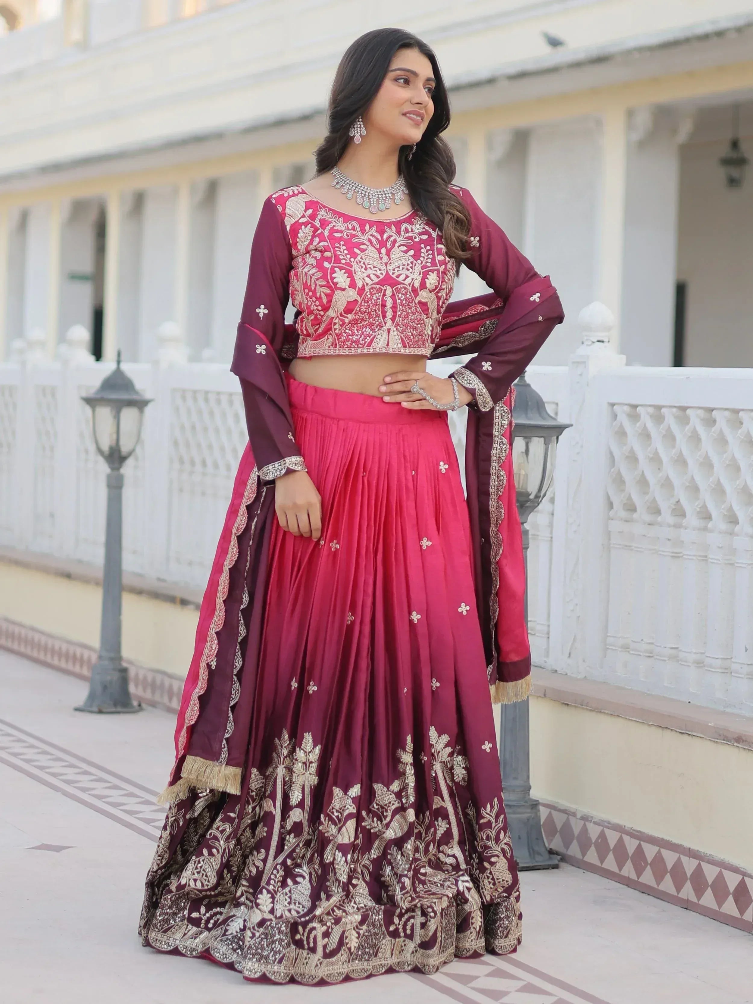 Elegant maroon and pink embroidered lehenga choli with gold detailing, perfect for Indian weddings and festive occasions.