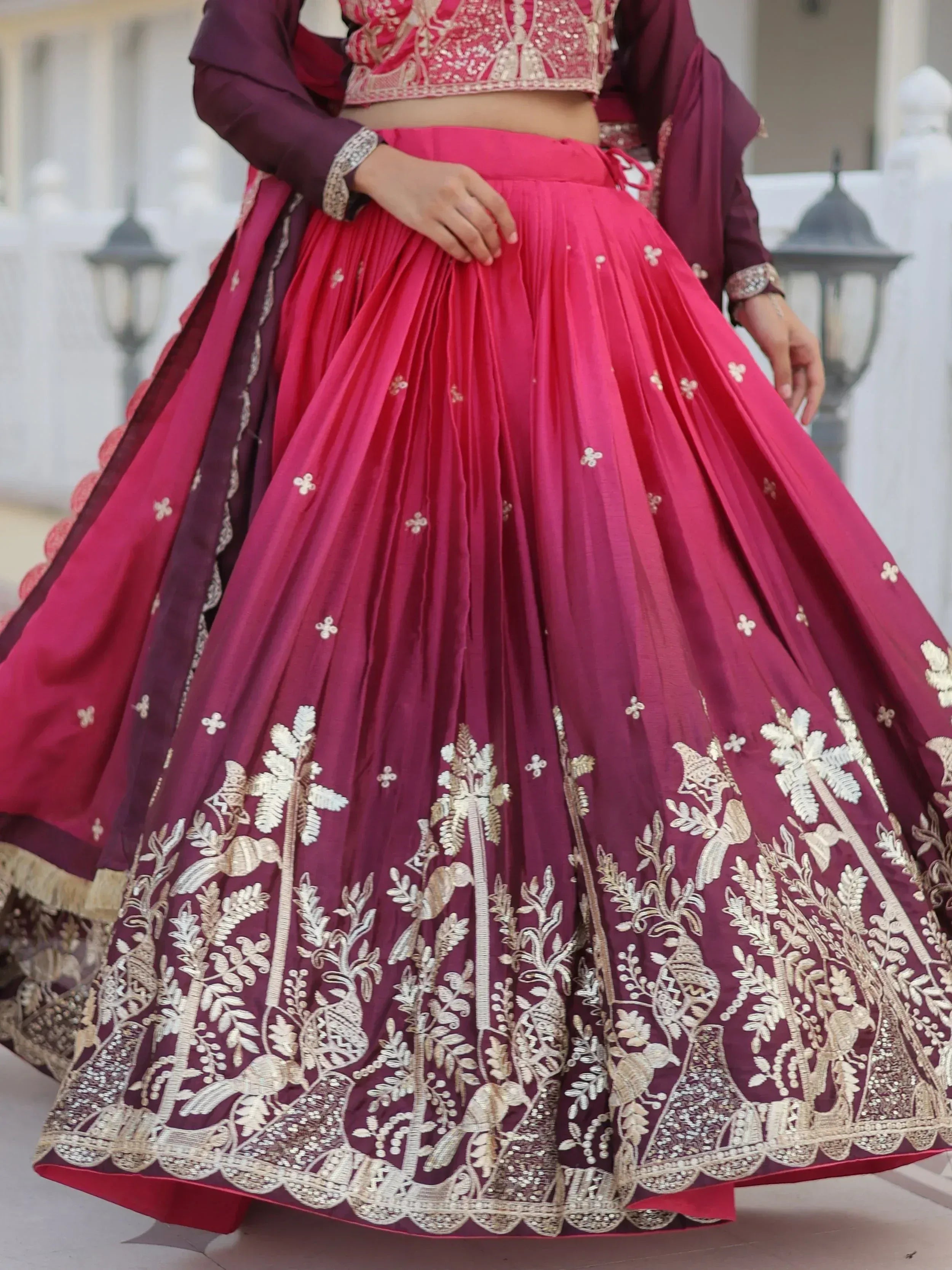 Pink and maroon designer lehenga choli with gold embroidery, perfect for Indian weddings and festive occasions.
