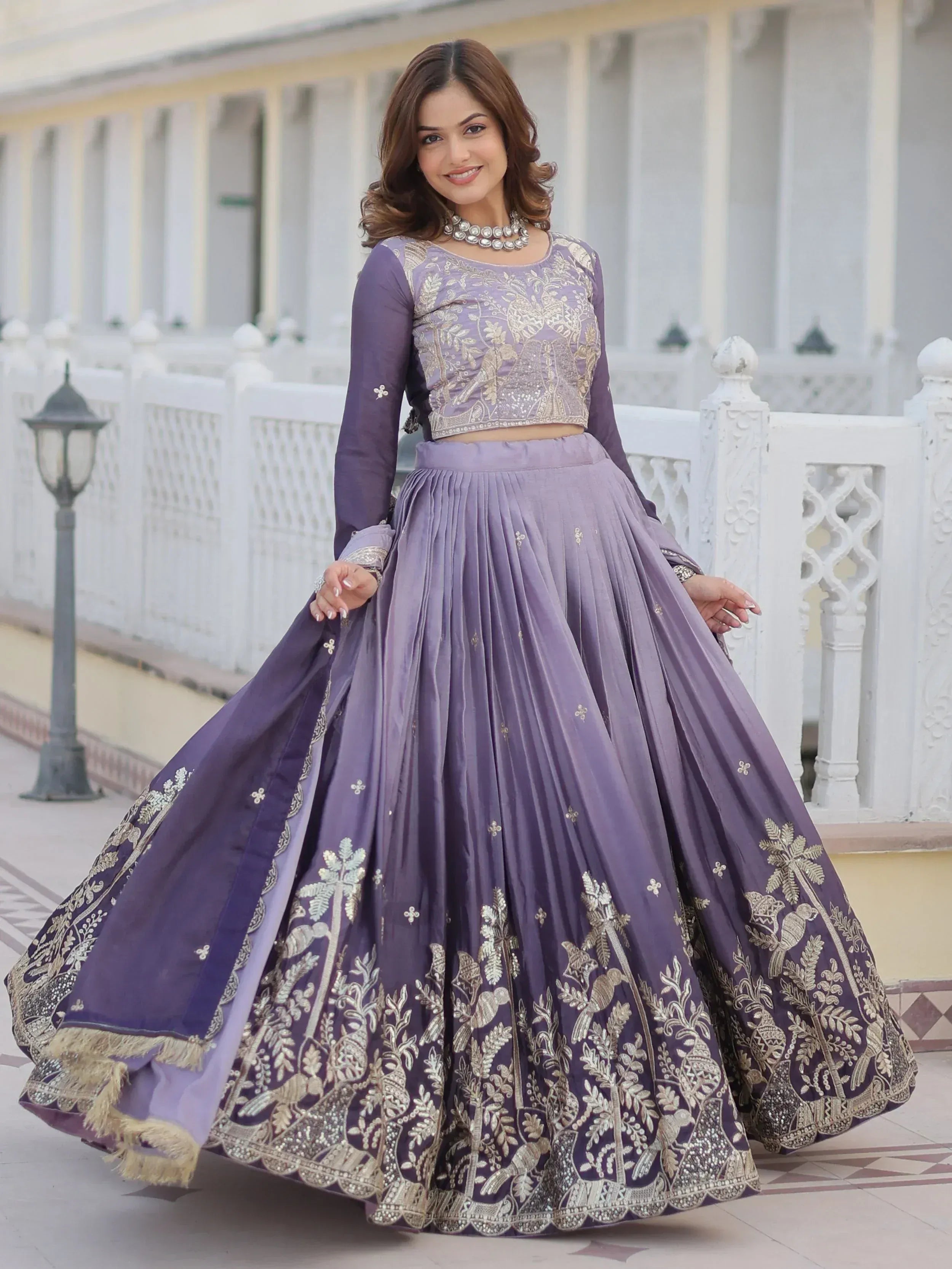 Purple embroidered lehenga choli with gold floral and bird motifs, perfect for Indian ethnic occasions.