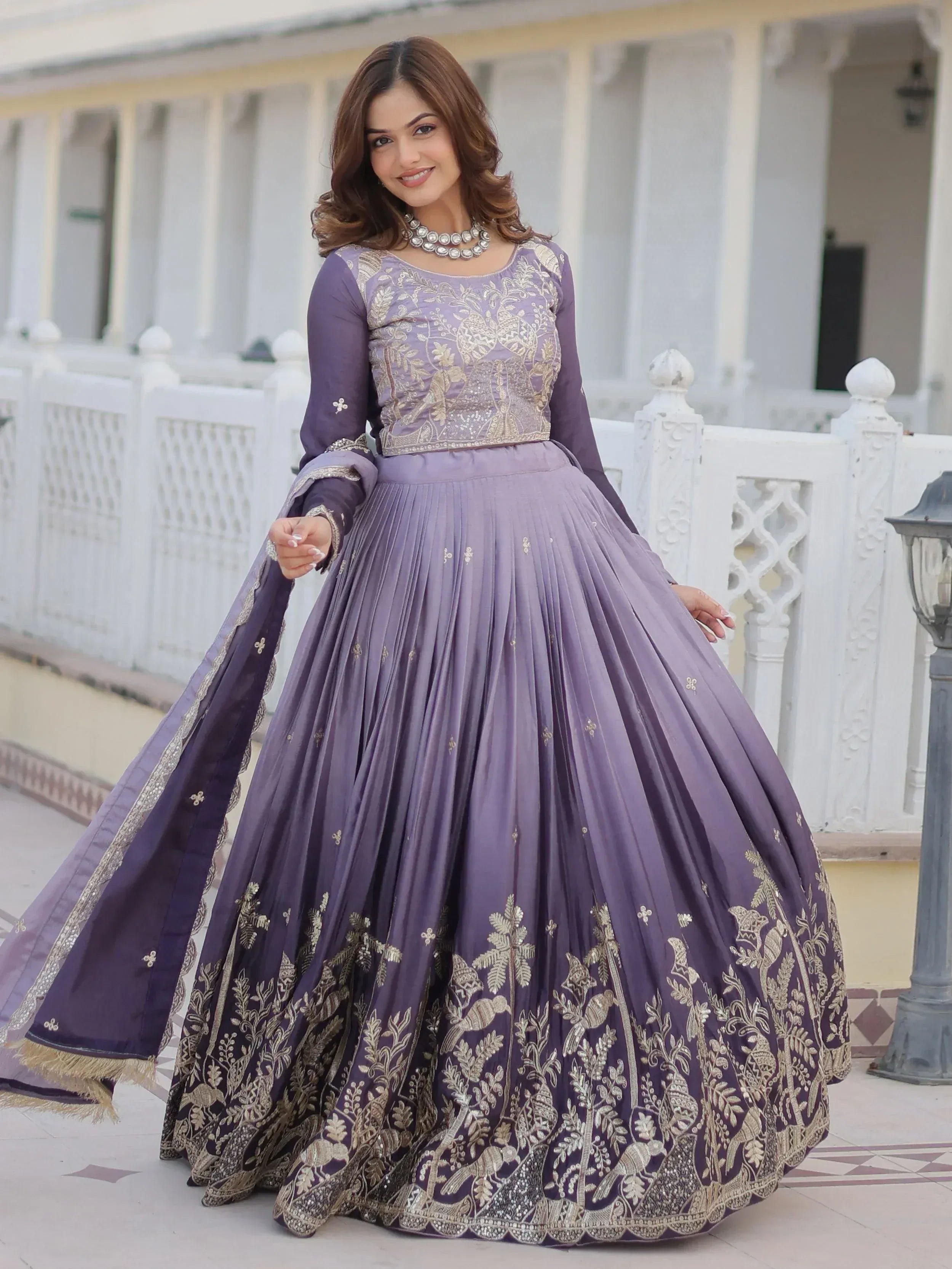 Purple embroidered lehenga choli with gold floral and bird motifs, perfect for Indian ethnic wear occasions.