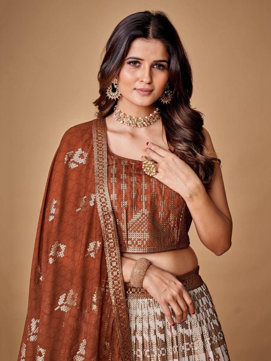 Brown embroidered lehenga choli with gold detailing, perfect for Indian ethnic wear occasions