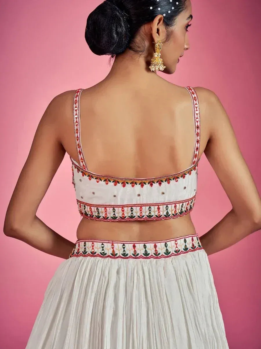 White embroidered lehenga choli with colorful mirror work, back view, ethnic Indian wear
