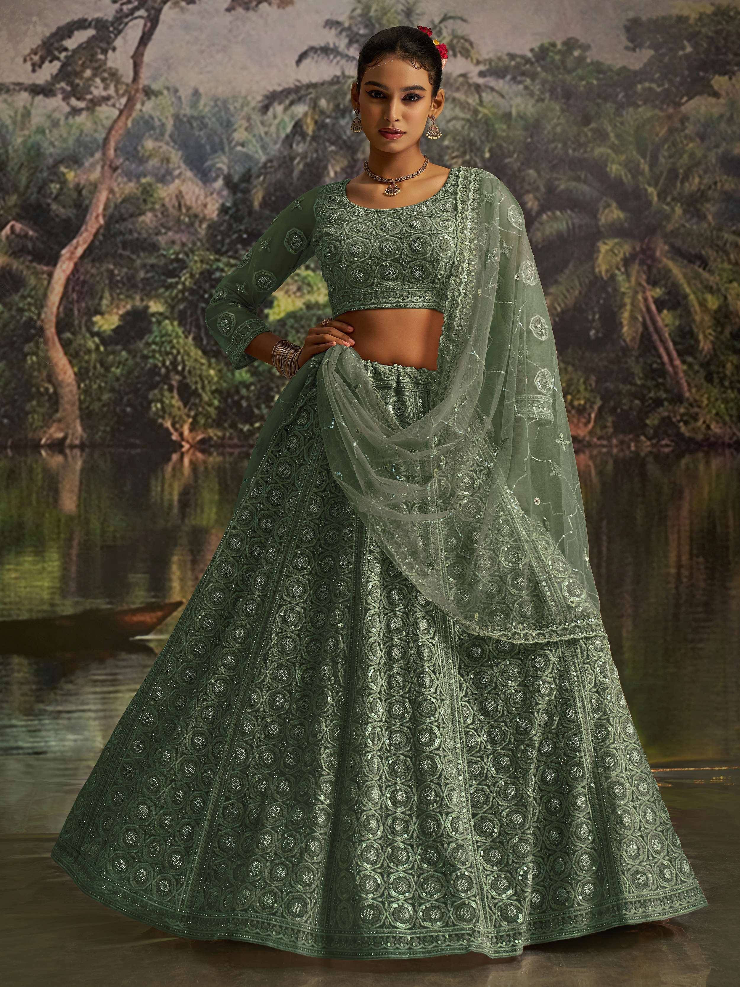 Green designer lehenga choli with intricate embroidery and sheer dupatta, perfect for Indian ethnic wear occasions.