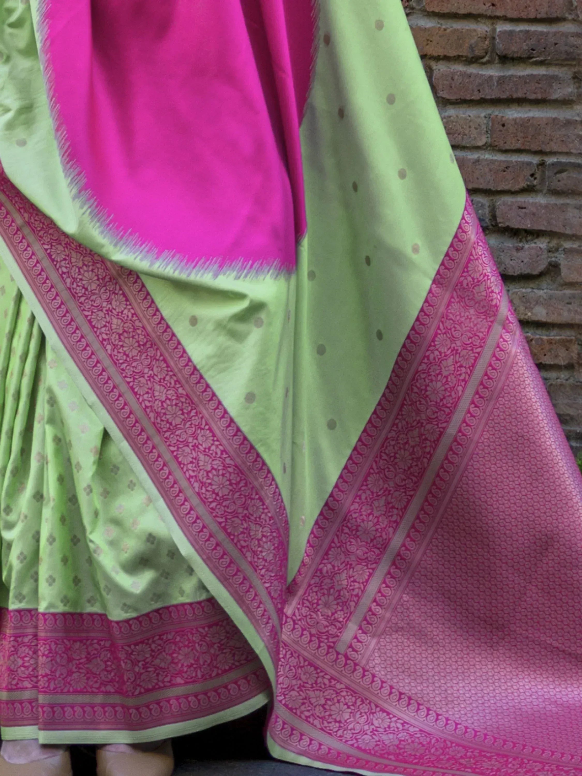 Vibrant green and pink designer saree with intricate border, perfect for Indian ethnic wear occasions.