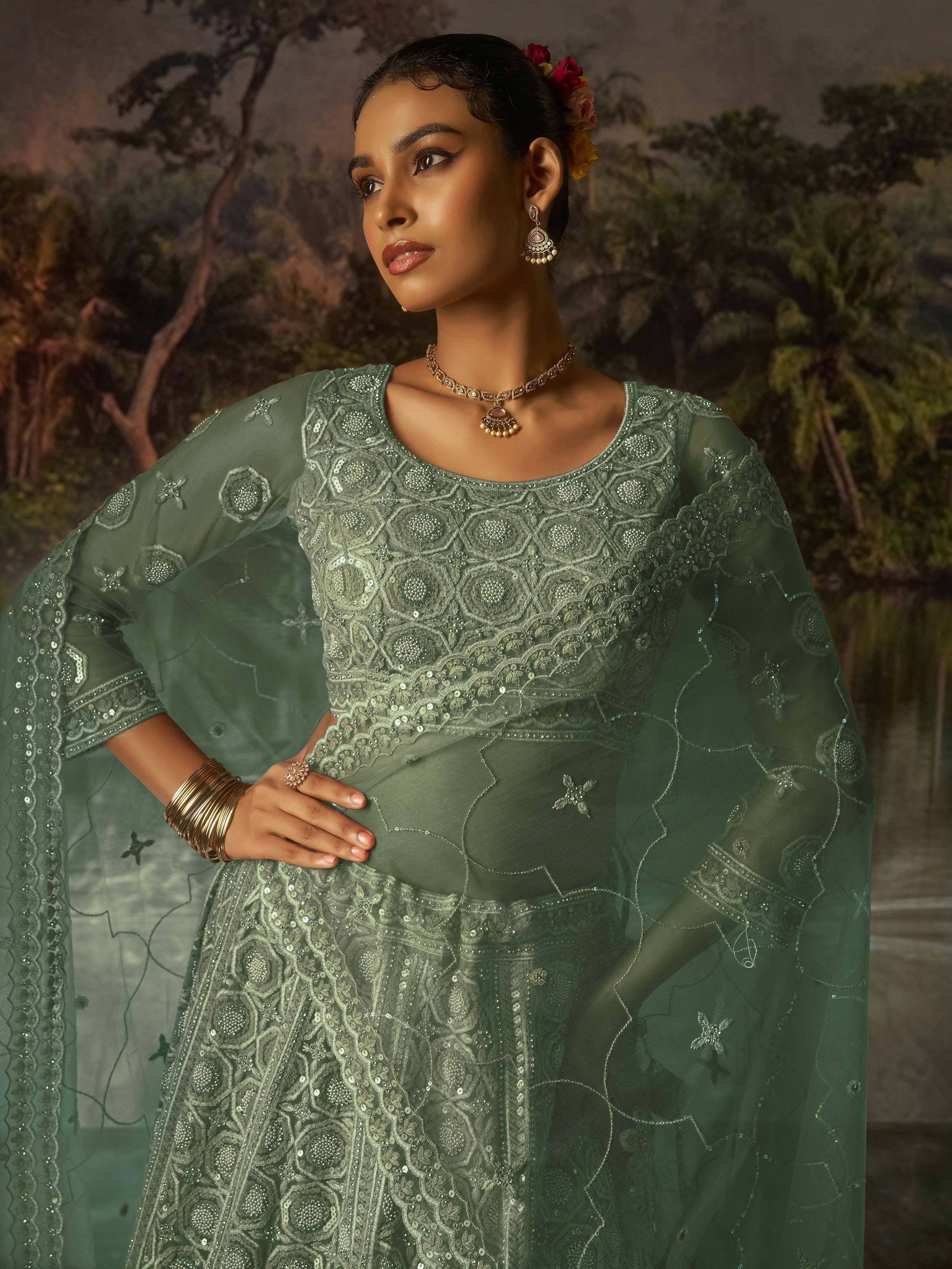 Elegant green embroidered lehenga choli with sheer dupatta, perfect for Indian ethnic occasions.