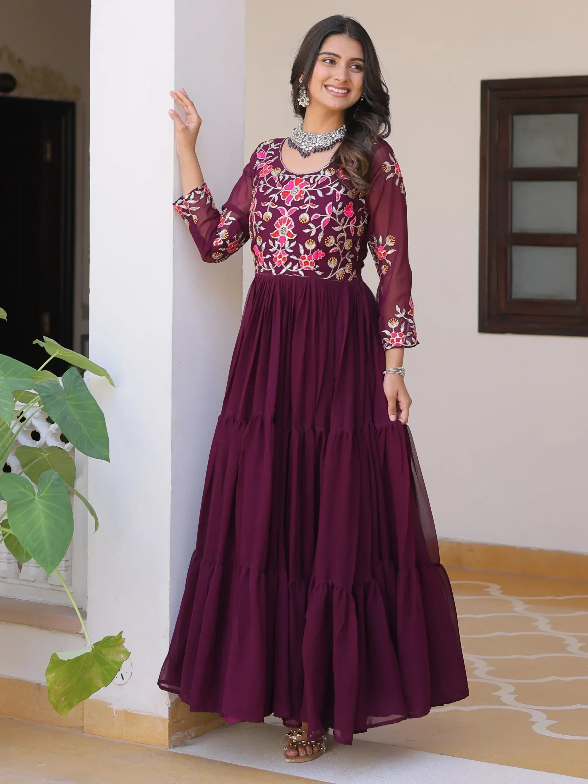 Maroon embroidered ethnic gown with floral design, perfect for Indian occasions and festive wear.