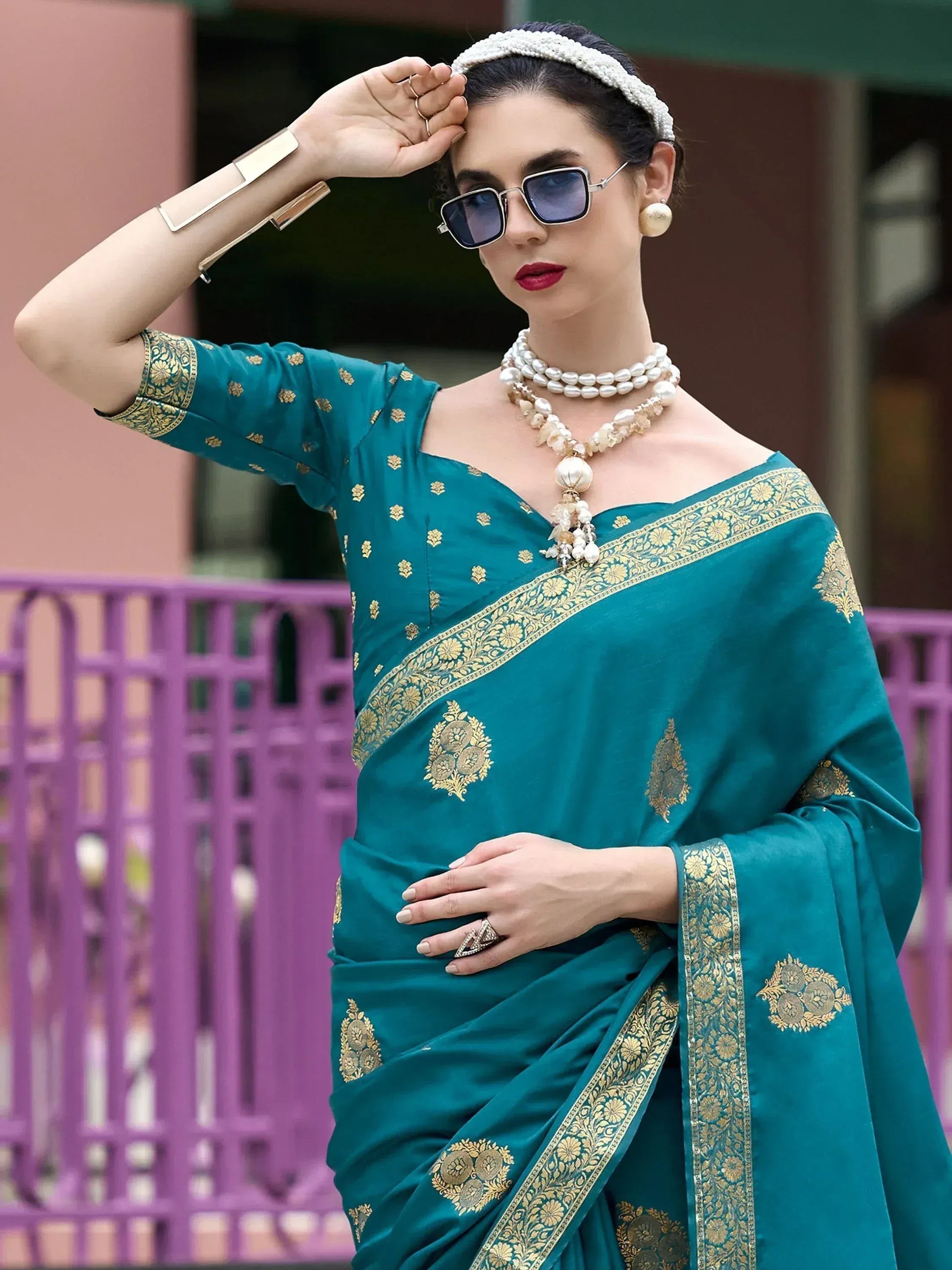 Teal saree with gold embroidery, pearl jewelry, and sunglasses for ethnic wear