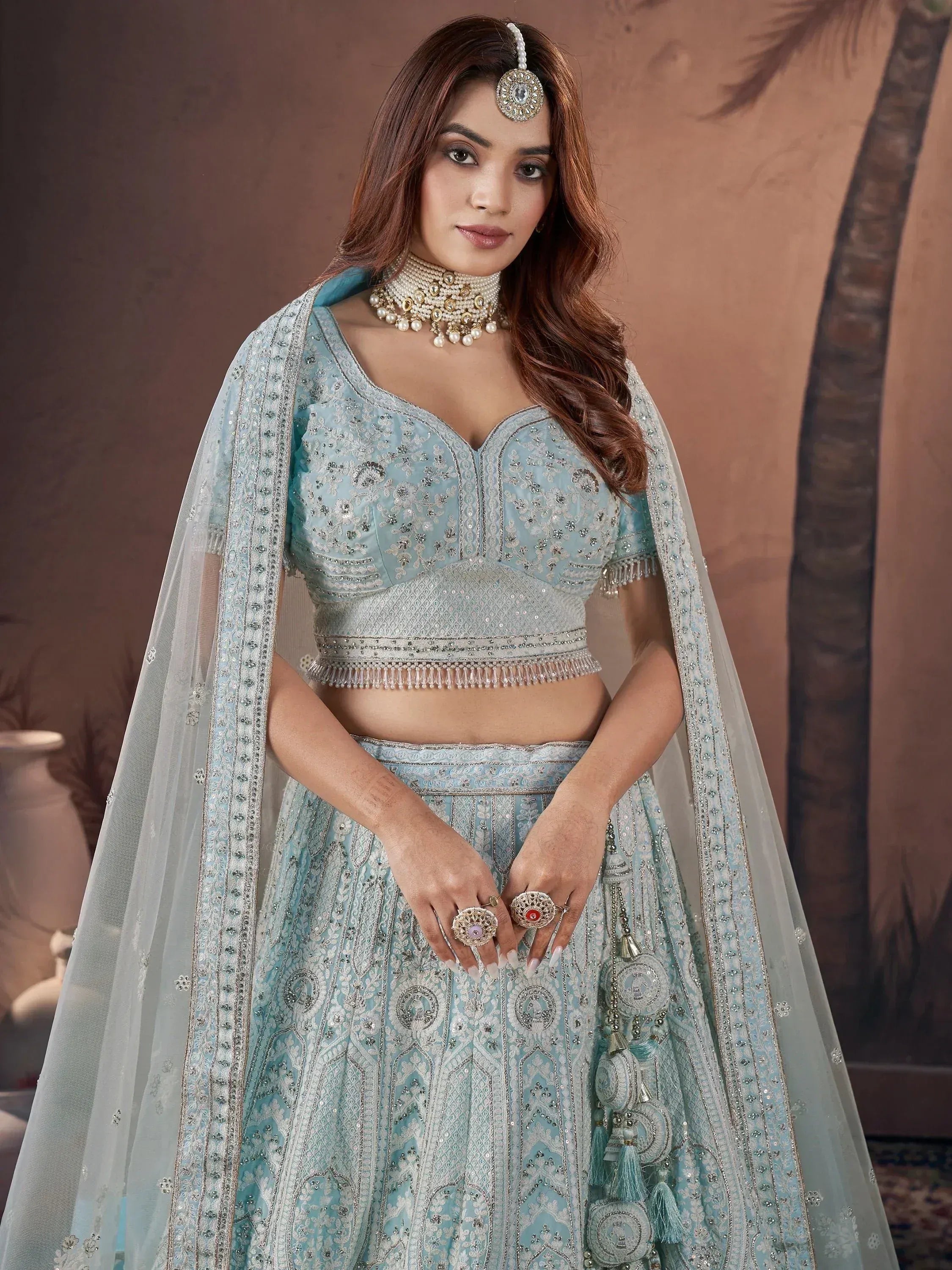 Light blue embroidered lehenga choli with dupatta, perfect for Indian weddings and festive occasions.