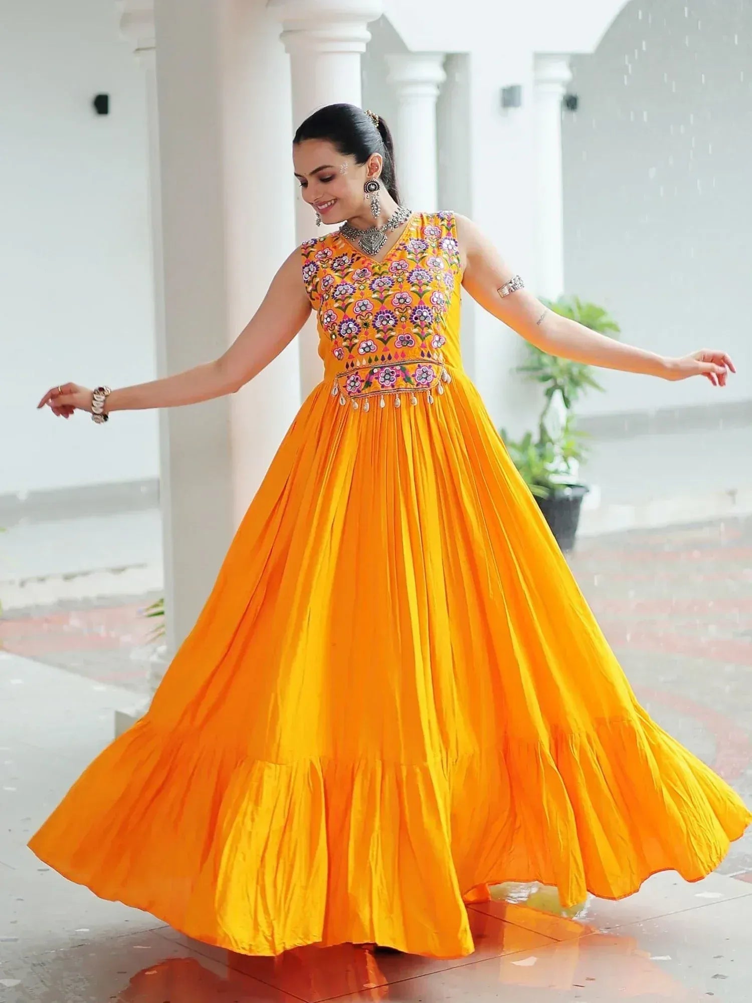 Vibrant yellow embroidered ethnic gown with flared skirt, perfect for festive occasions and celebrations.
