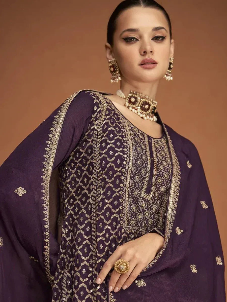 Purple embroidered salwar kameez with gold detailing, perfect for ethnic wear and festive occasions.
