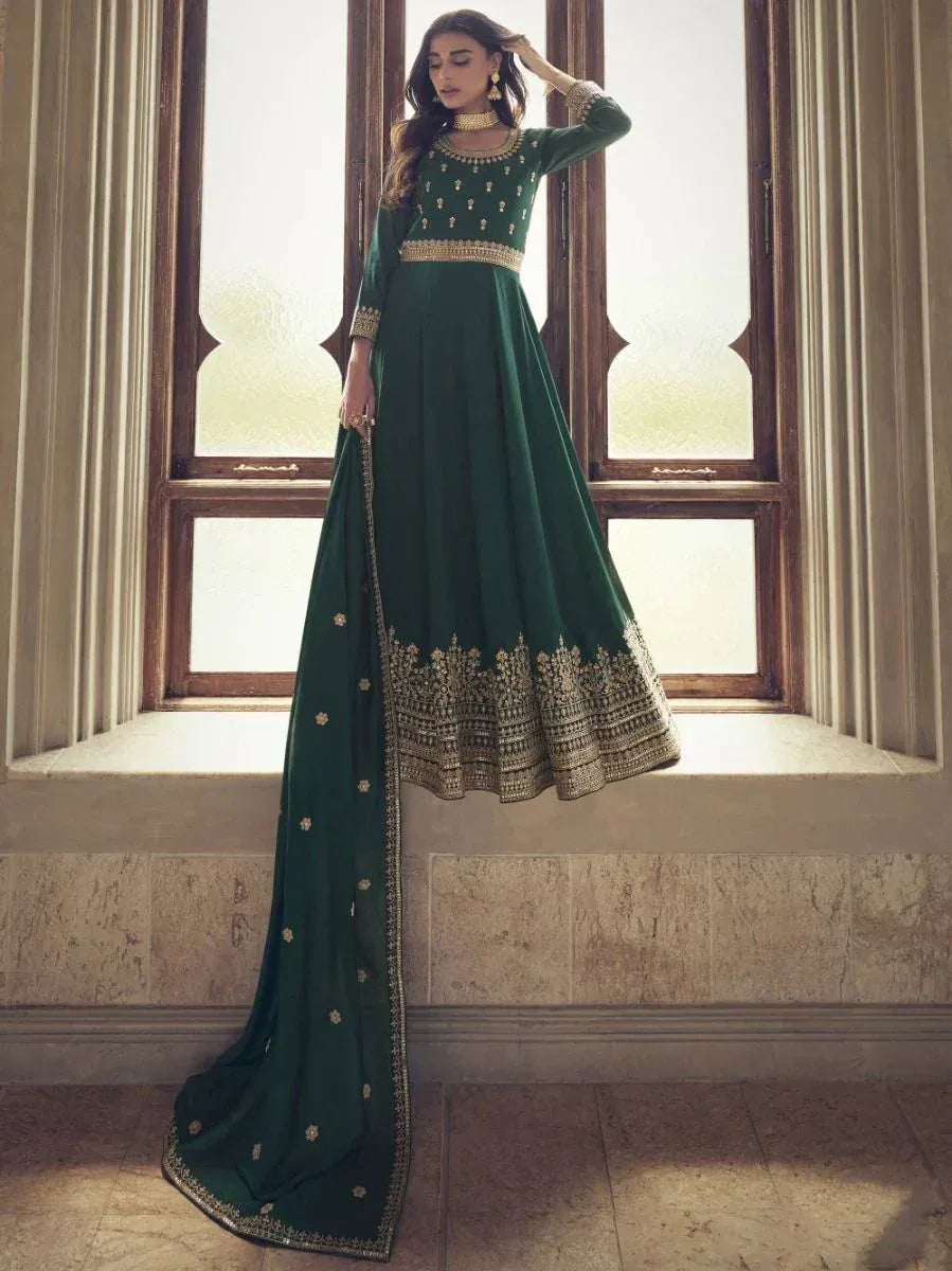 Emerald green ethnic gown with gold embroidery, perfect for Indian weddings and festive occasions