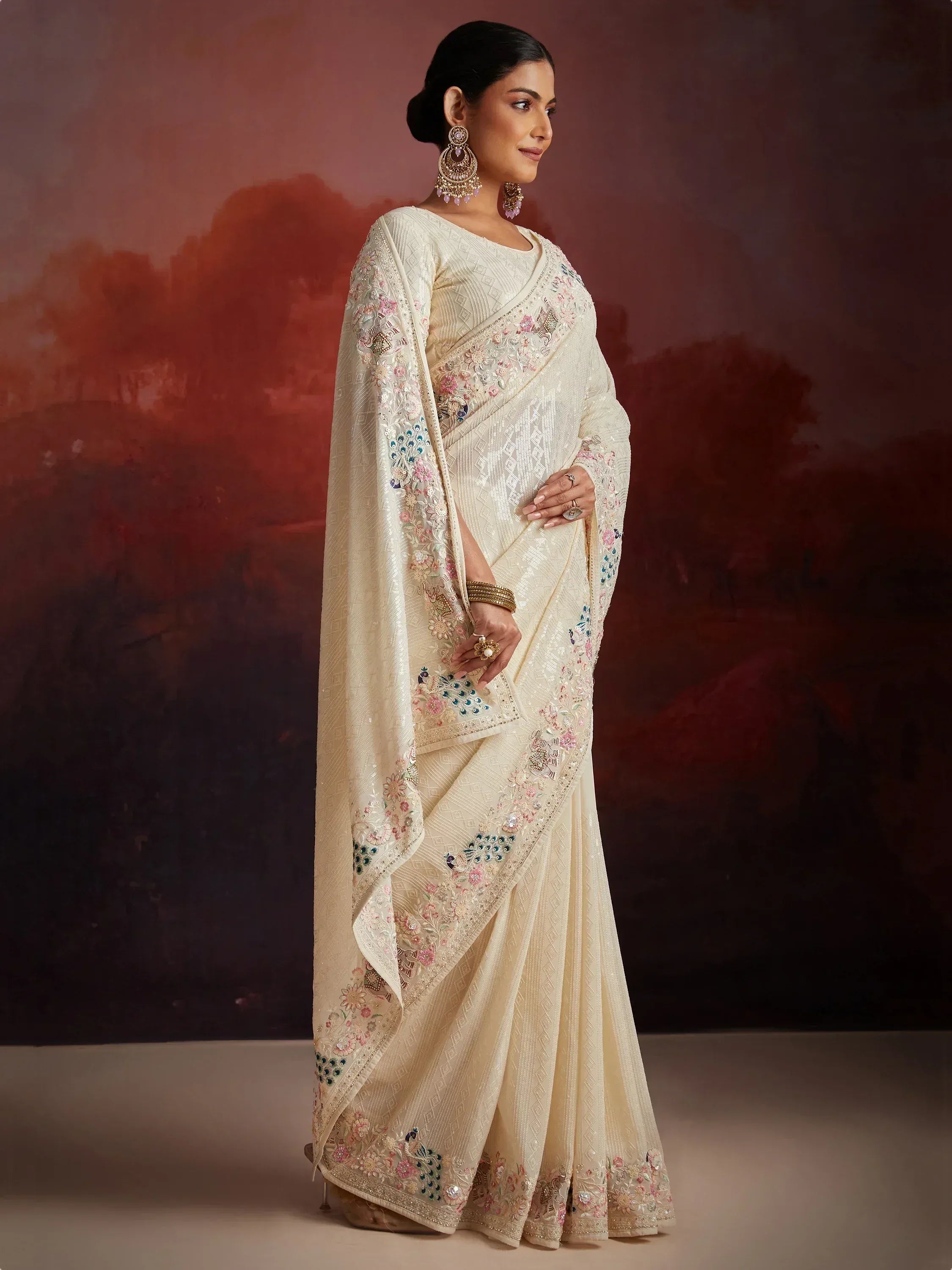 Cream embroidered saree with floral and peacock motifs, perfect for Indian ethnic occasions