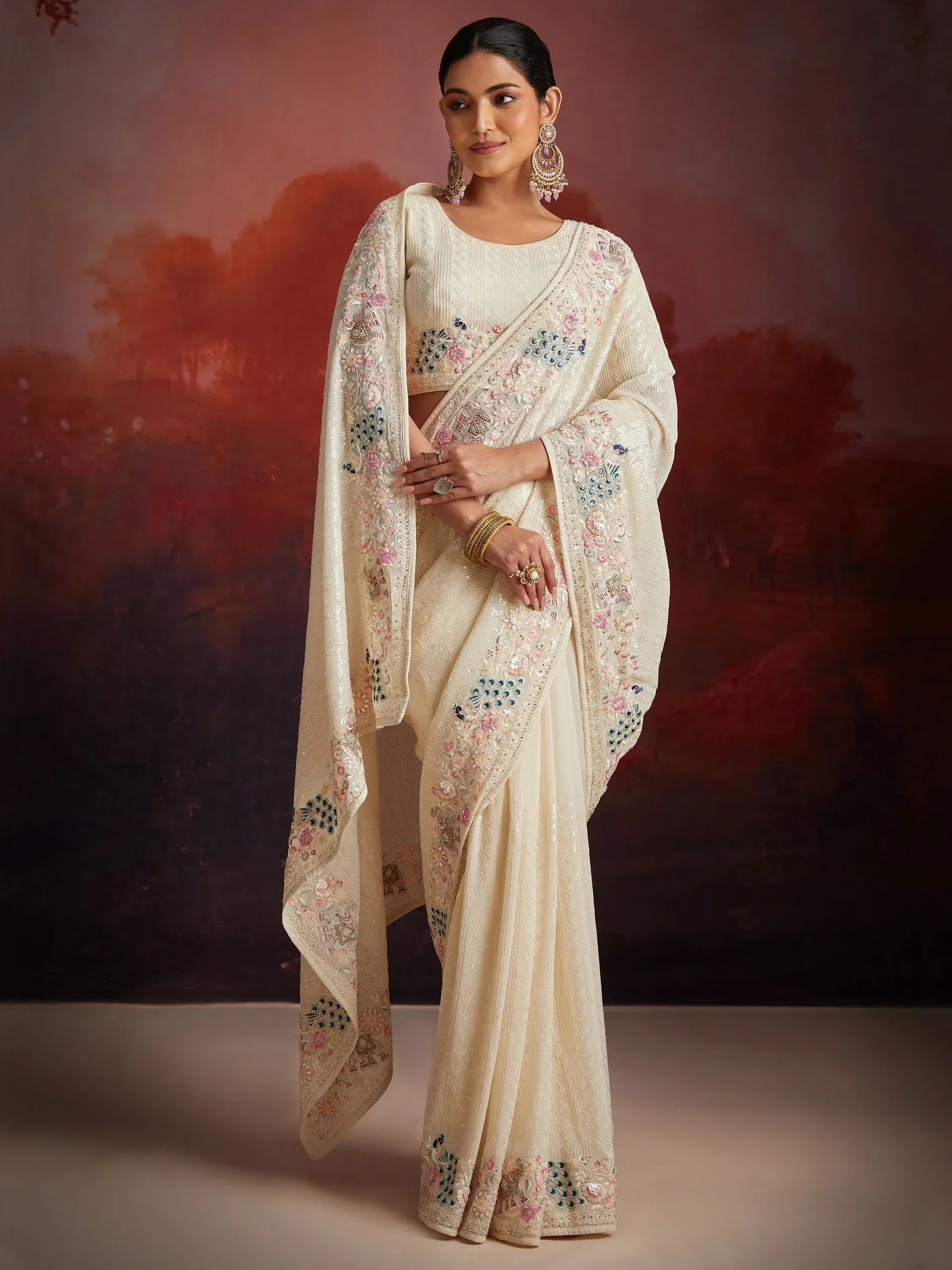 Cream embroidered saree with floral and peacock motifs, perfect for Indian ethnic wear occasions
