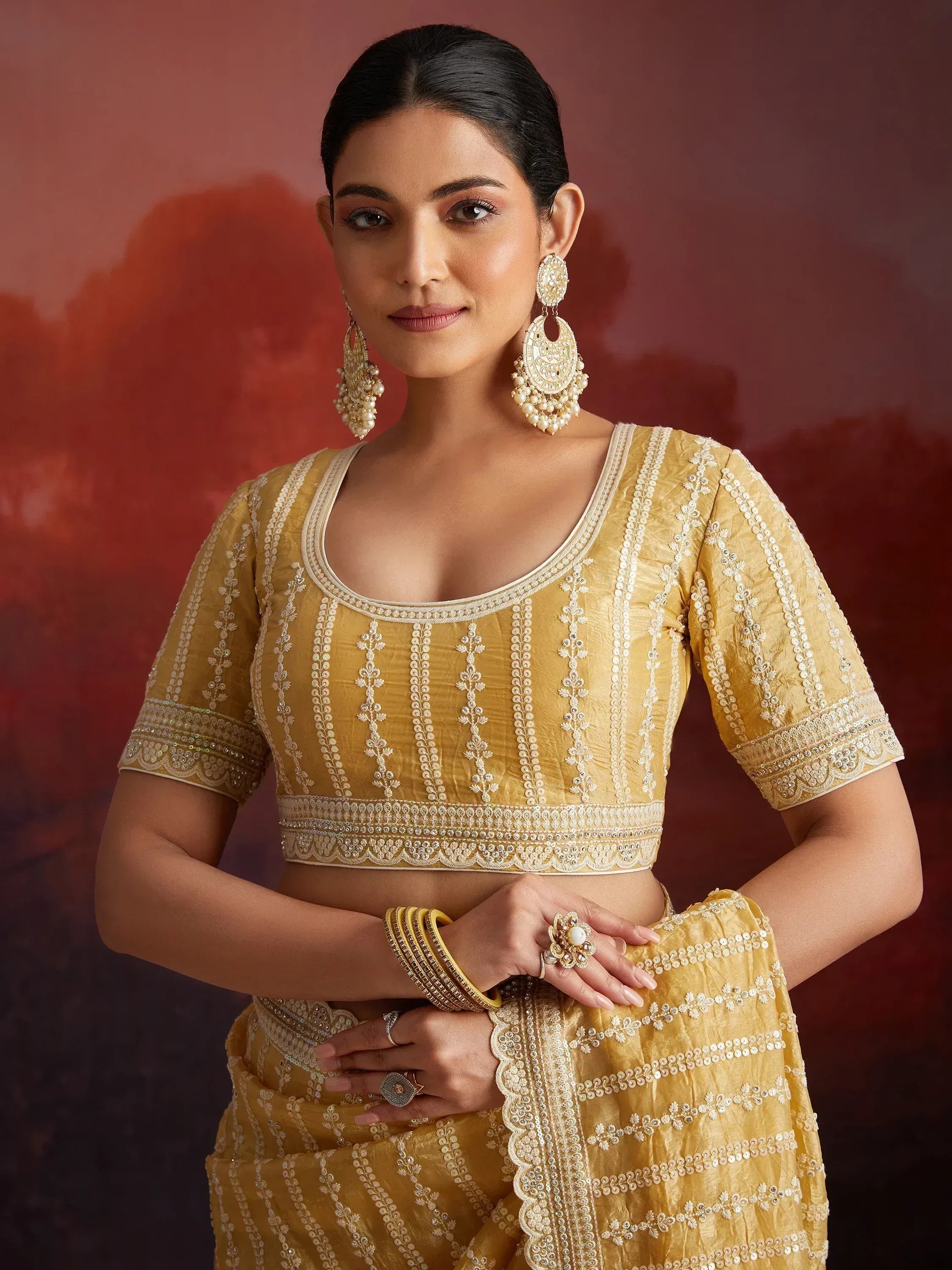Yellow embroidered lehenga choli with pearl jewelry, Indian ethnic wear for weddings and festivals