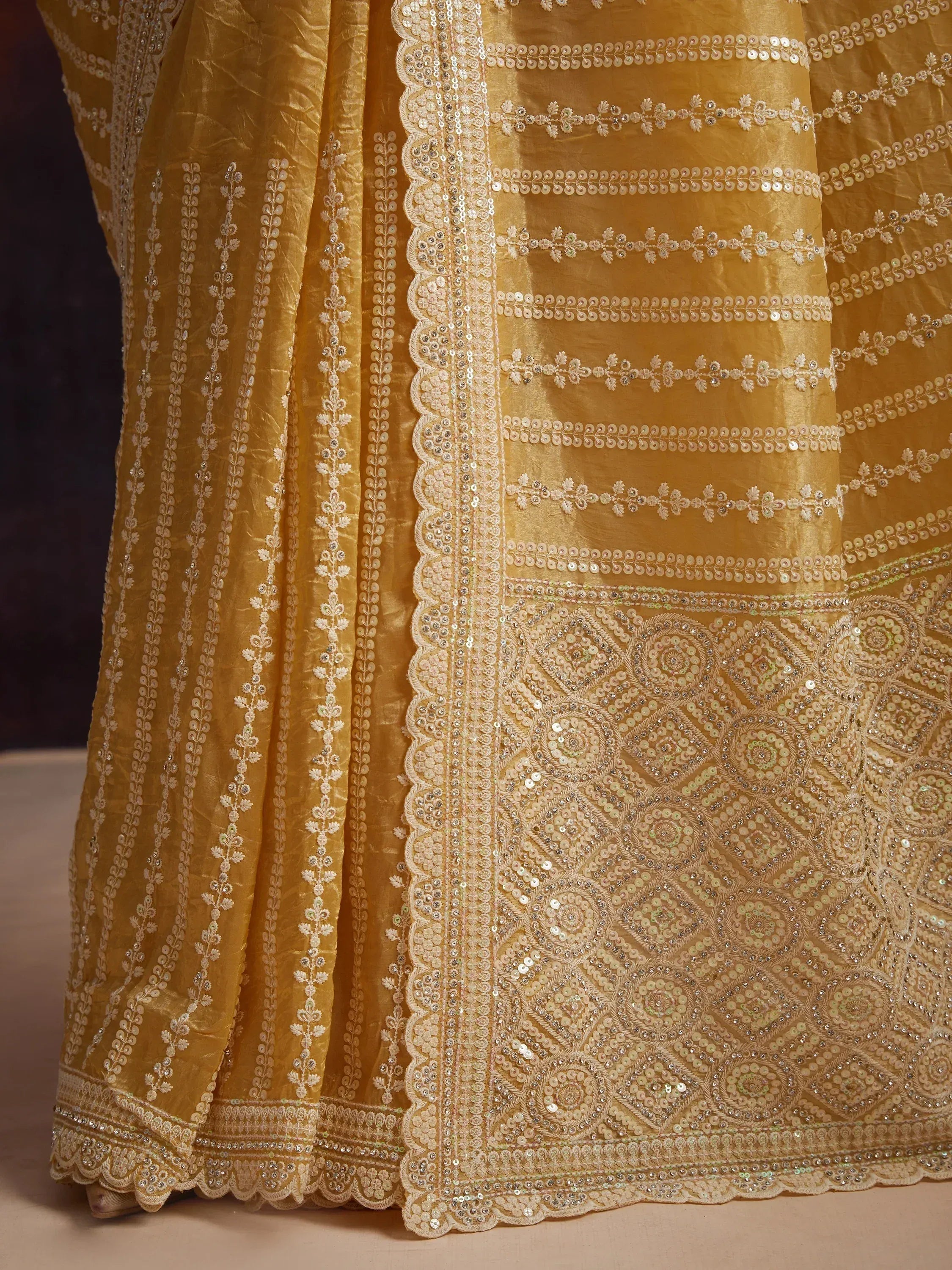Golden ethnic lehenga with intricate sequin and thread embroidery, perfect for Indian weddings and festive occasions.