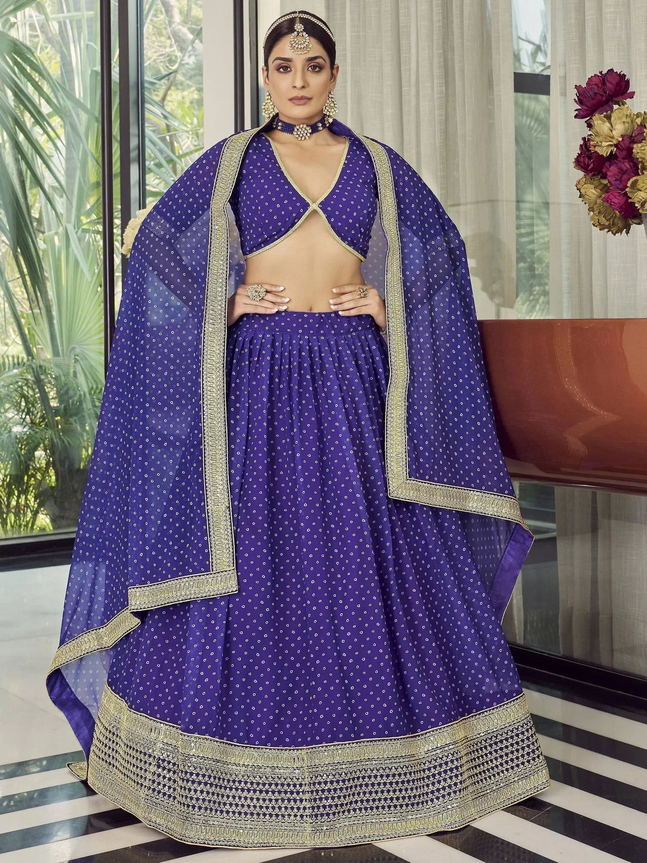 Purple designer lehenga choli with gold embroidery and cape, perfect for Indian ethnic wear events