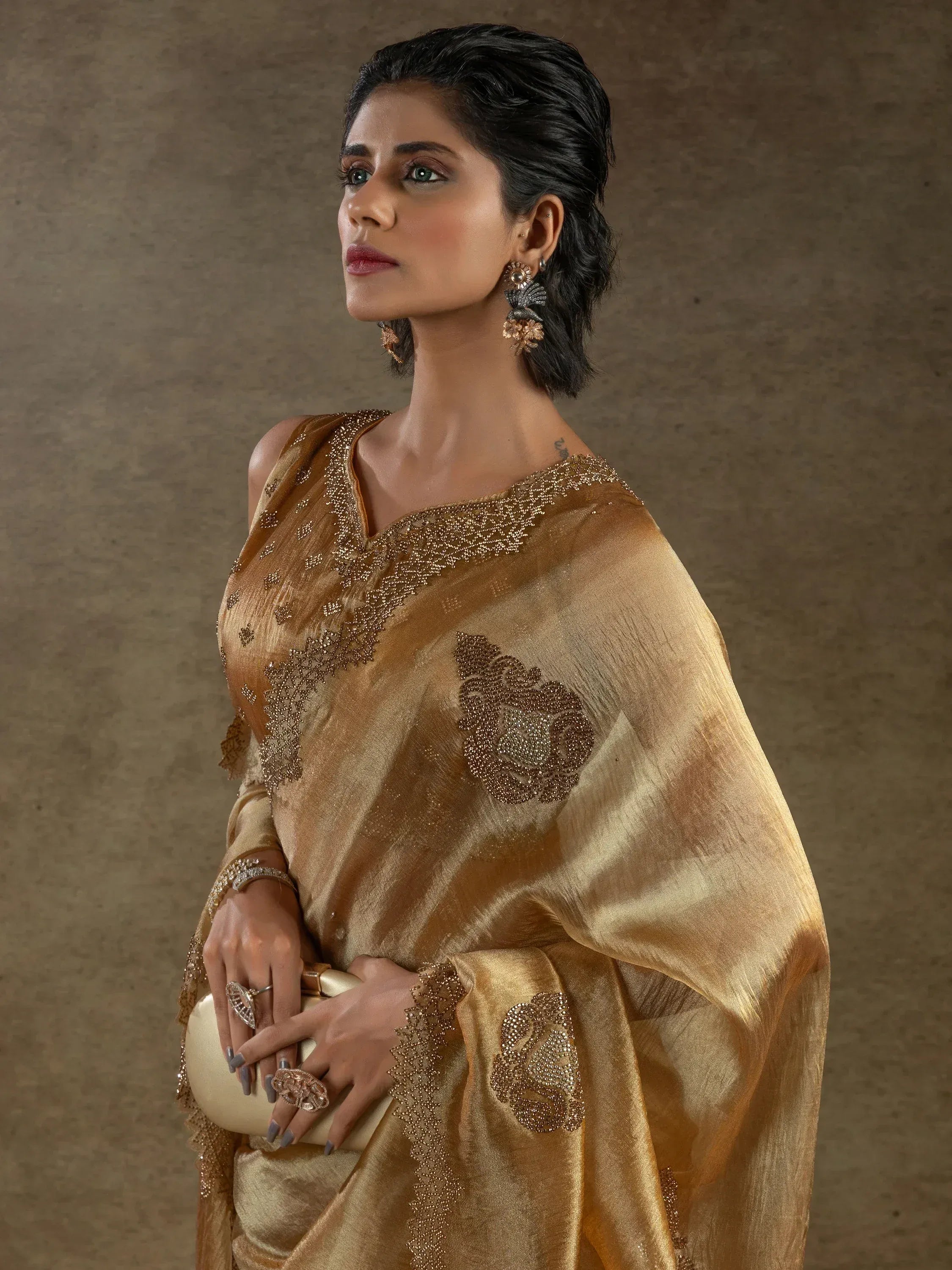 Elegant golden saree with intricate embroidery and embellishments, perfect for Indian ethnic wear.