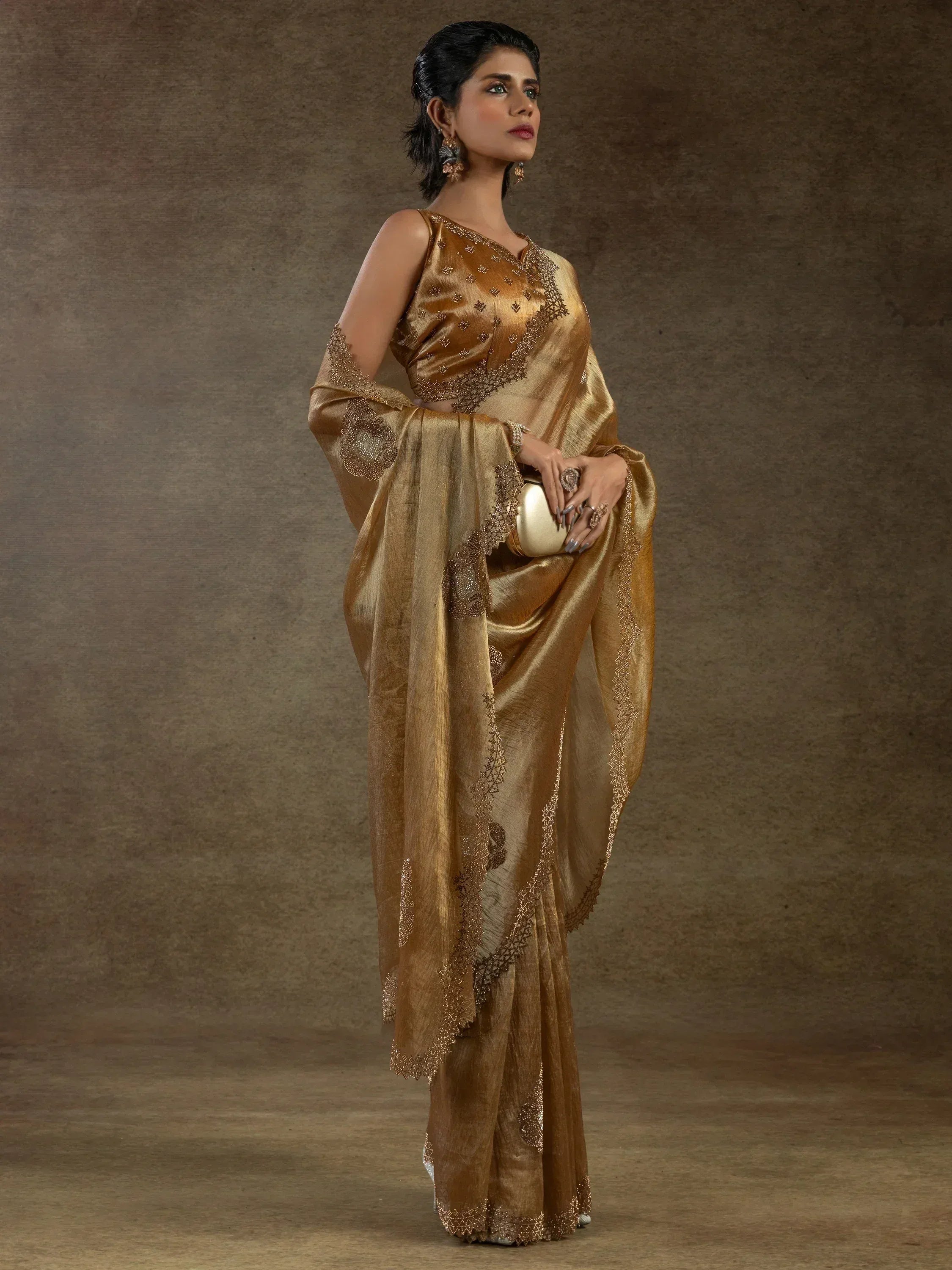 Golden embroidered saree with designer blouse, perfect for ethnic occasions and festive wear.