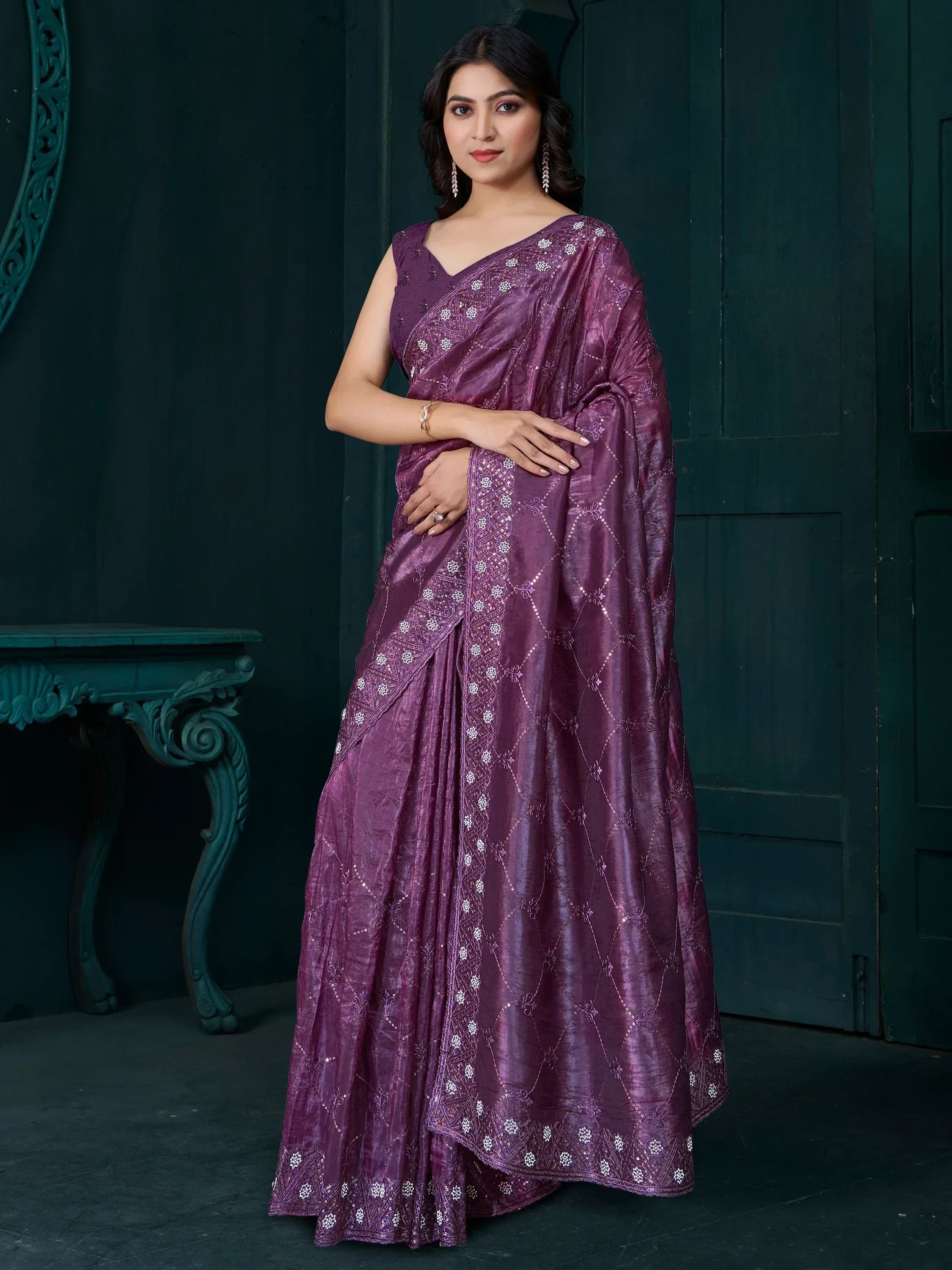 Elegant purple saree with intricate white embroidery and shimmering texture, perfect for festive occasions.