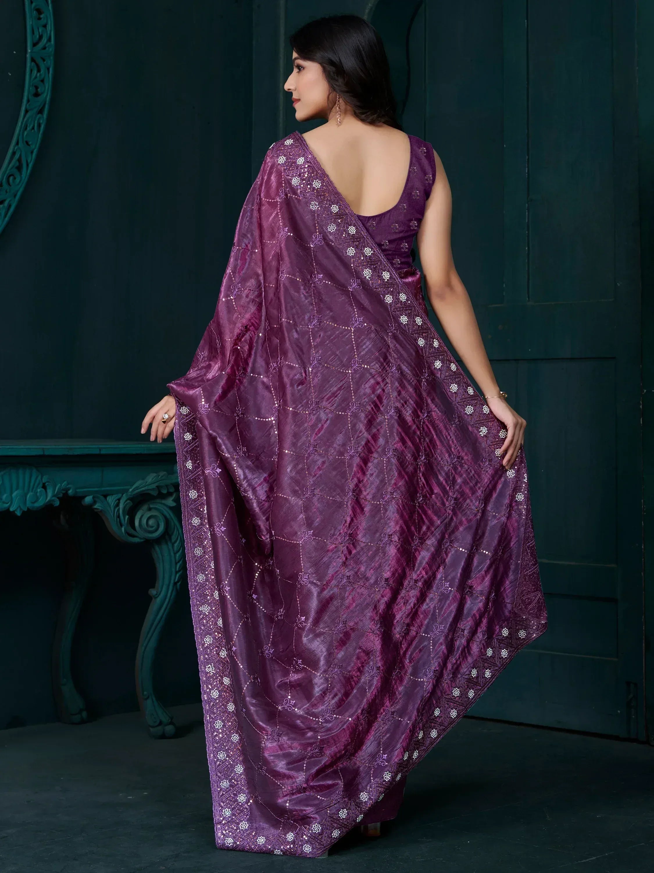 Elegant purple saree with intricate embroidery and sequin detailing, perfect for ethnic occasions.