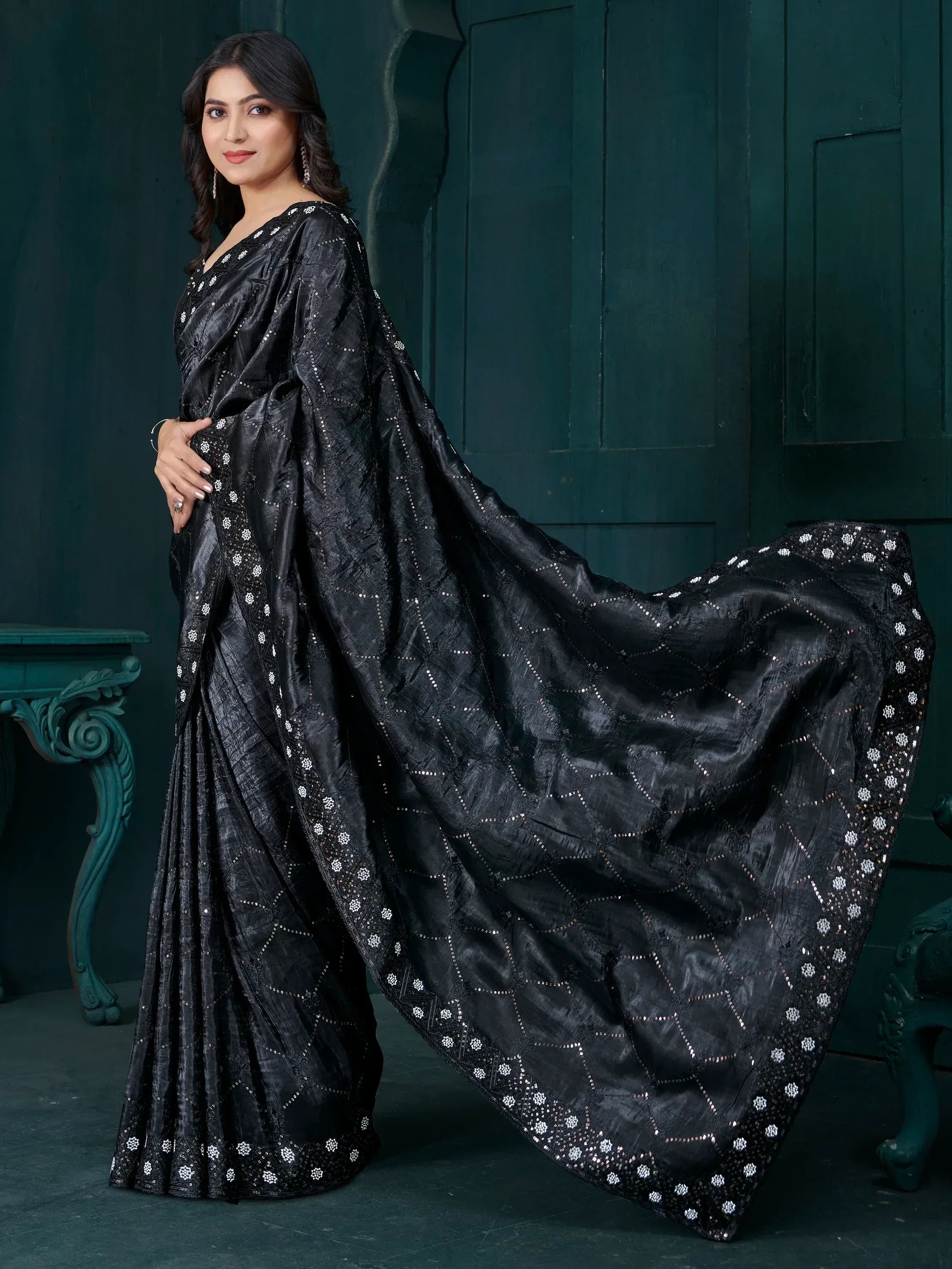 Elegant black saree with intricate white embroidery, perfect for ethnic wear occasions.