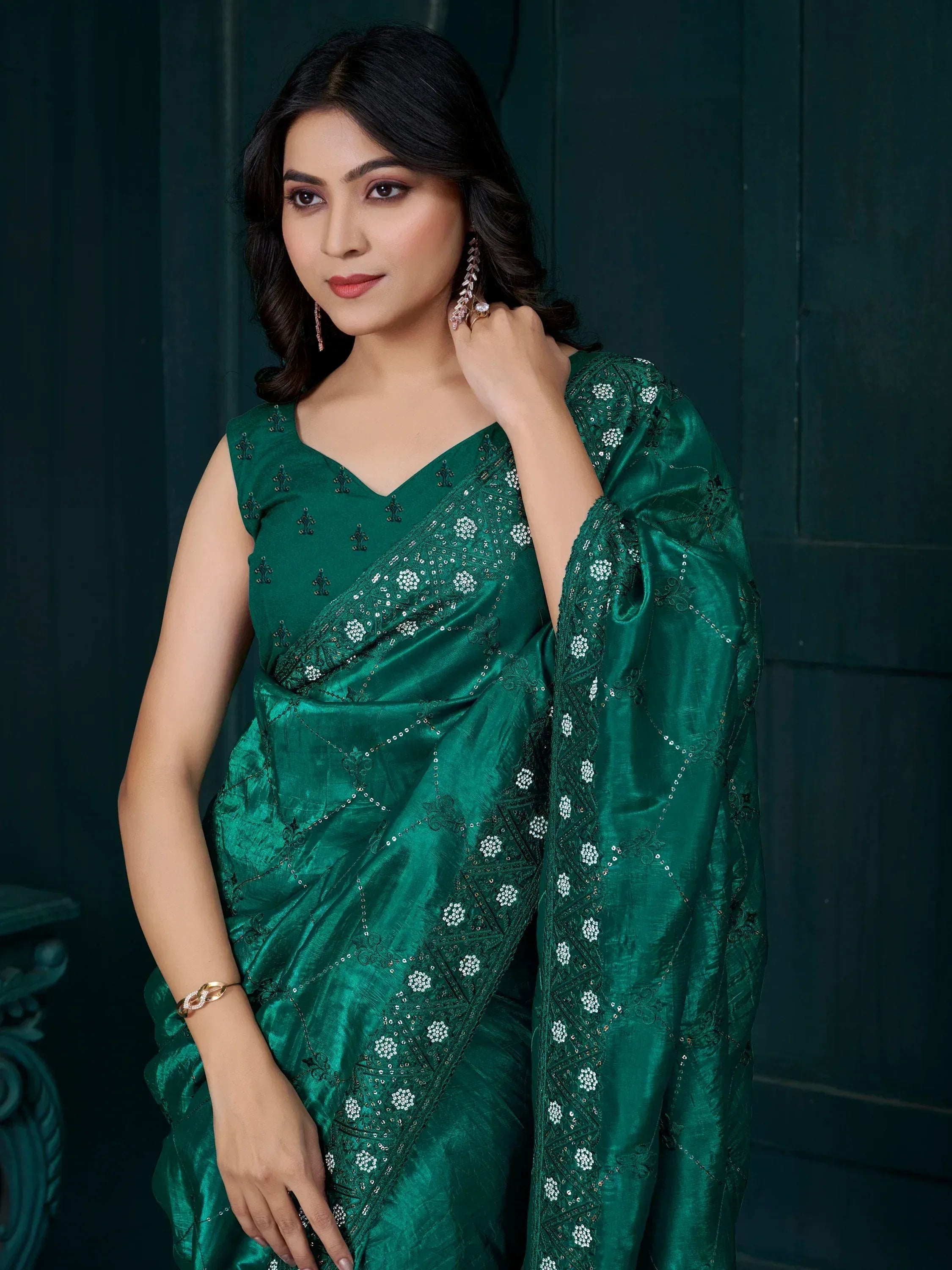 Emerald green designer saree with intricate embroidery and sequin work, perfect for ethnic occasions.