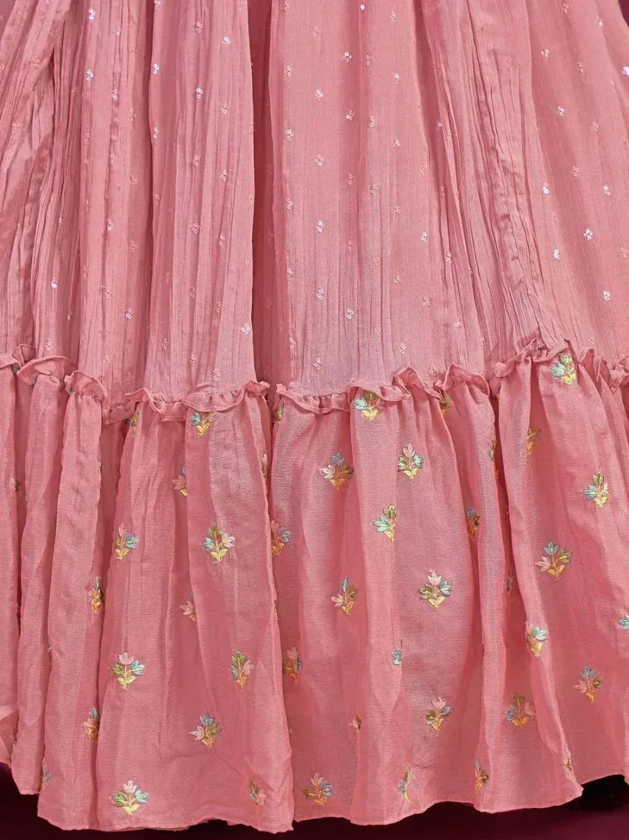 Pink embroidered lehenga skirt with floral motifs and ruffled hem, ideal for ethnic wear occasions