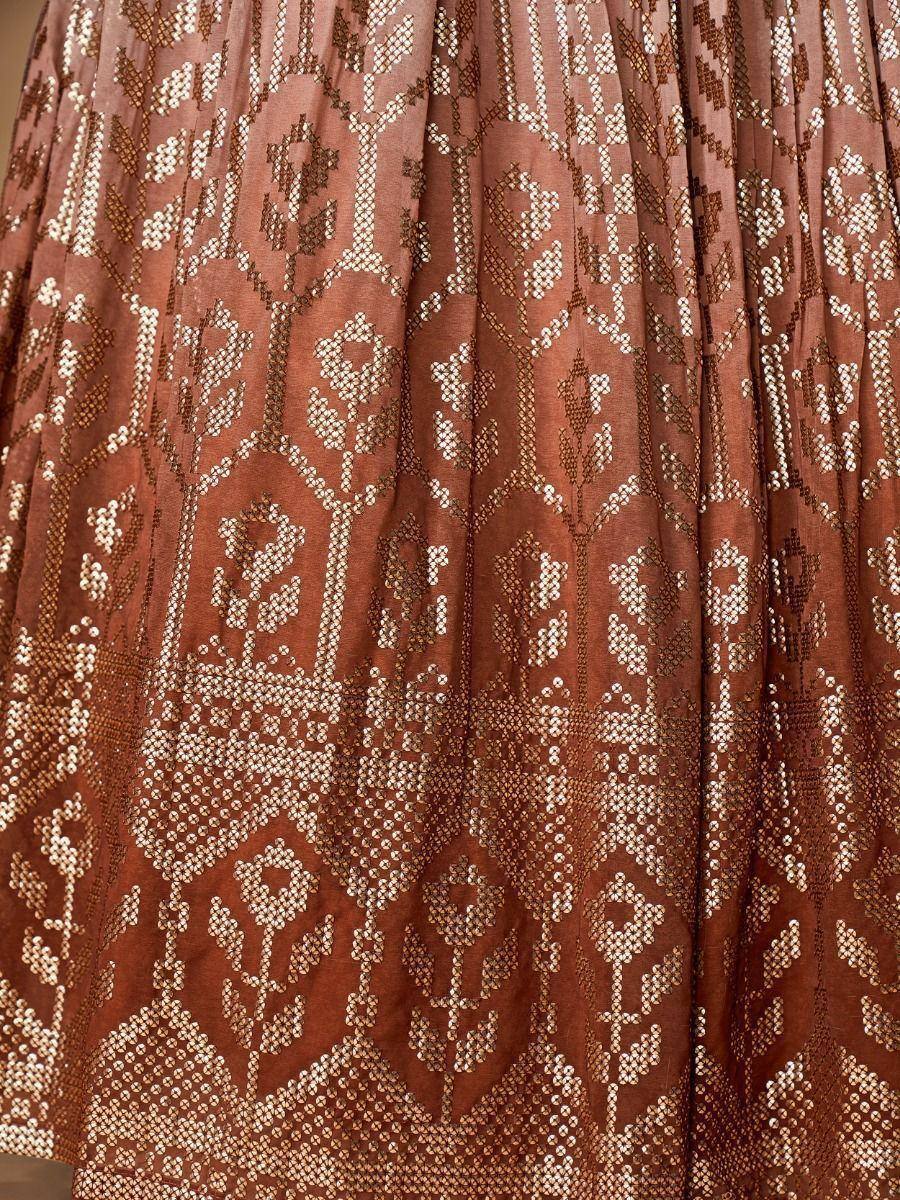 Brown ethnic lehenga skirt with intricate geometric and floral embroidery, perfect for Indian weddings and festive occasions.