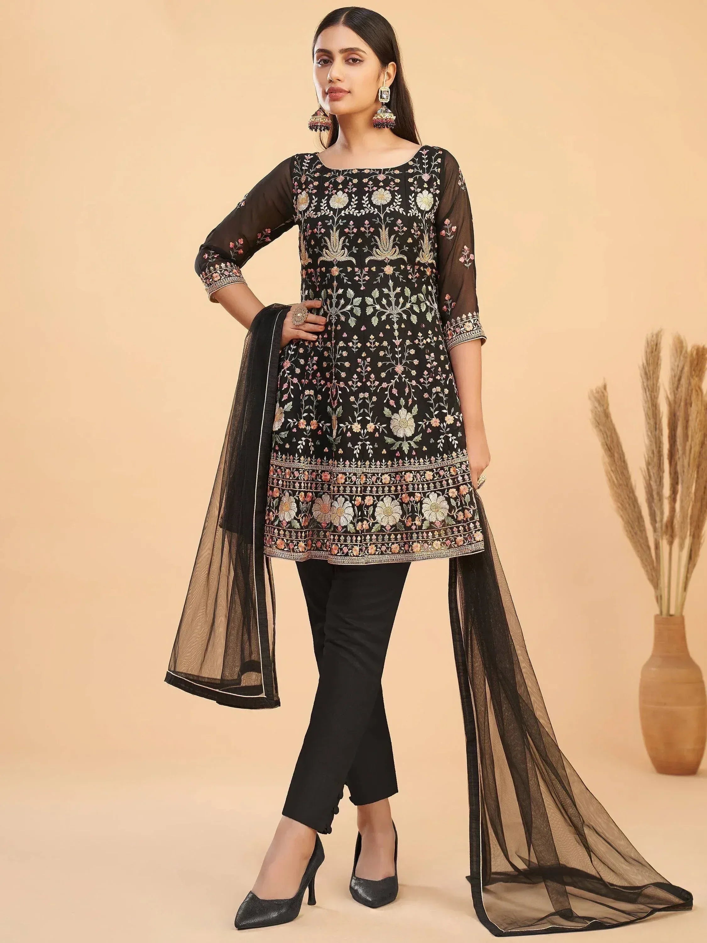 Black embroidered ethnic kurti with floral design, paired with pants and sheer dupatta