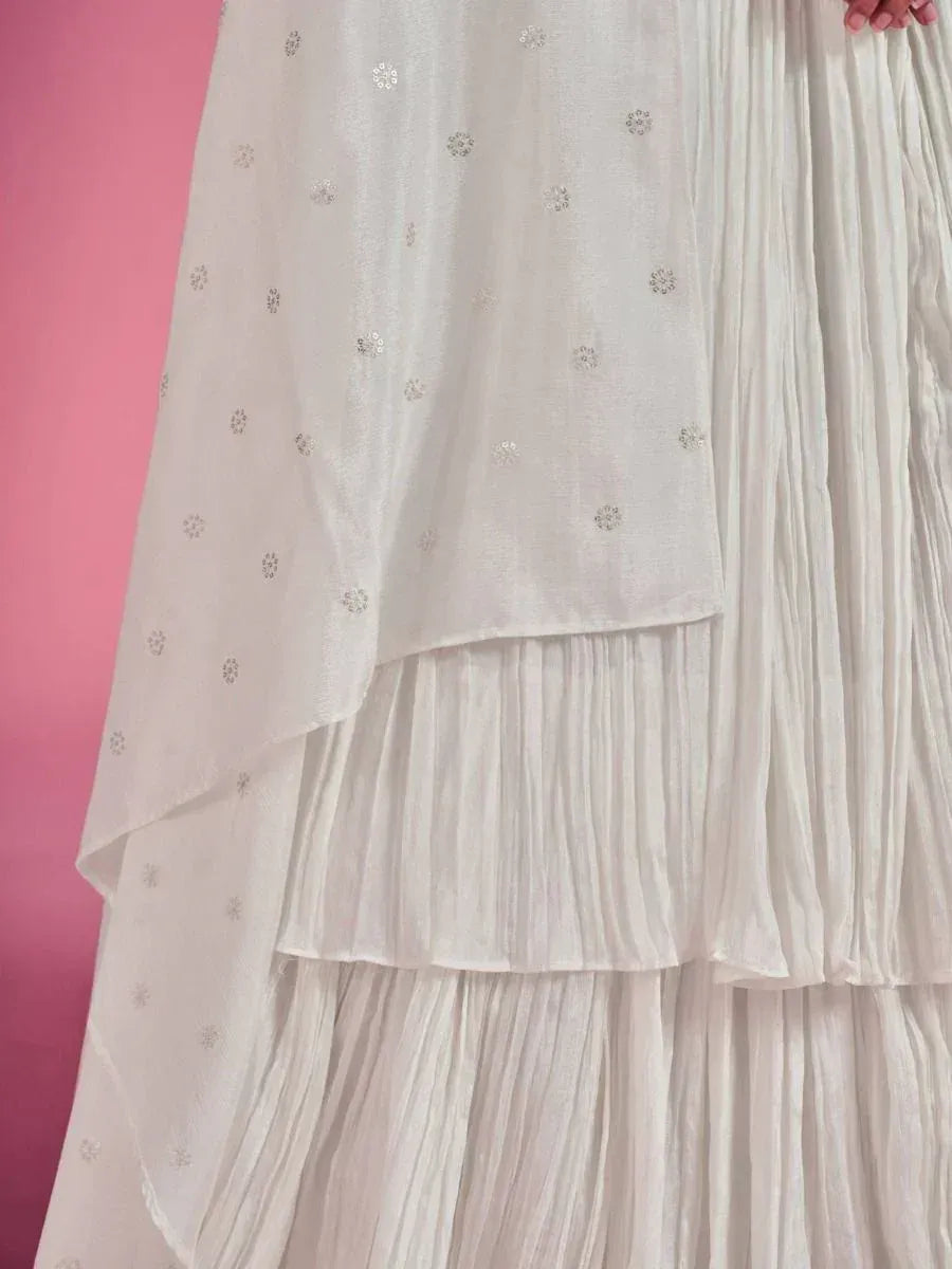 White pleated ethnic gown with floral sequin detailing, perfect for Indian festive occasions.