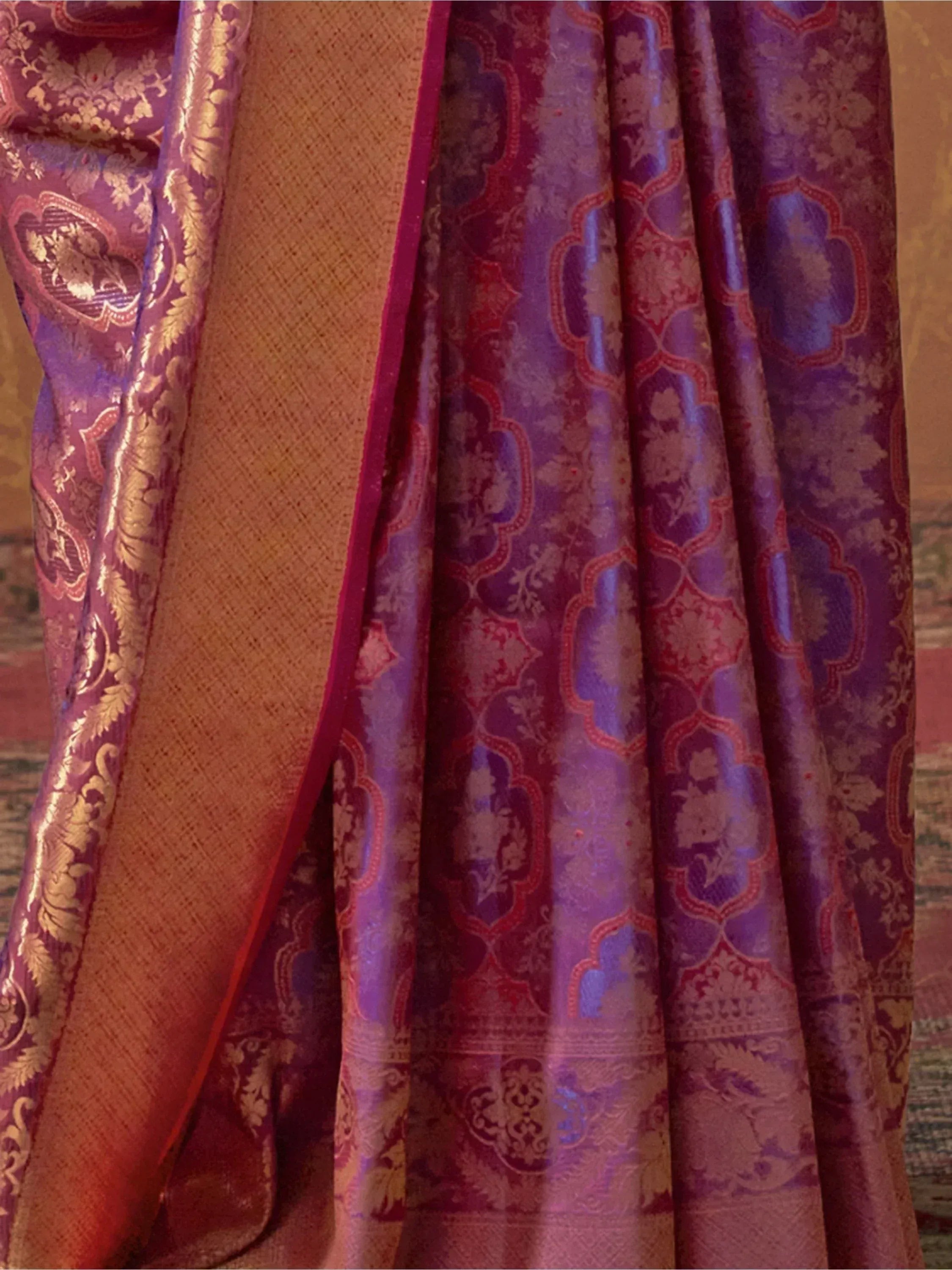 Purple and gold designer saree with intricate floral and paisley brocade patterns, perfect for ethnic wear.