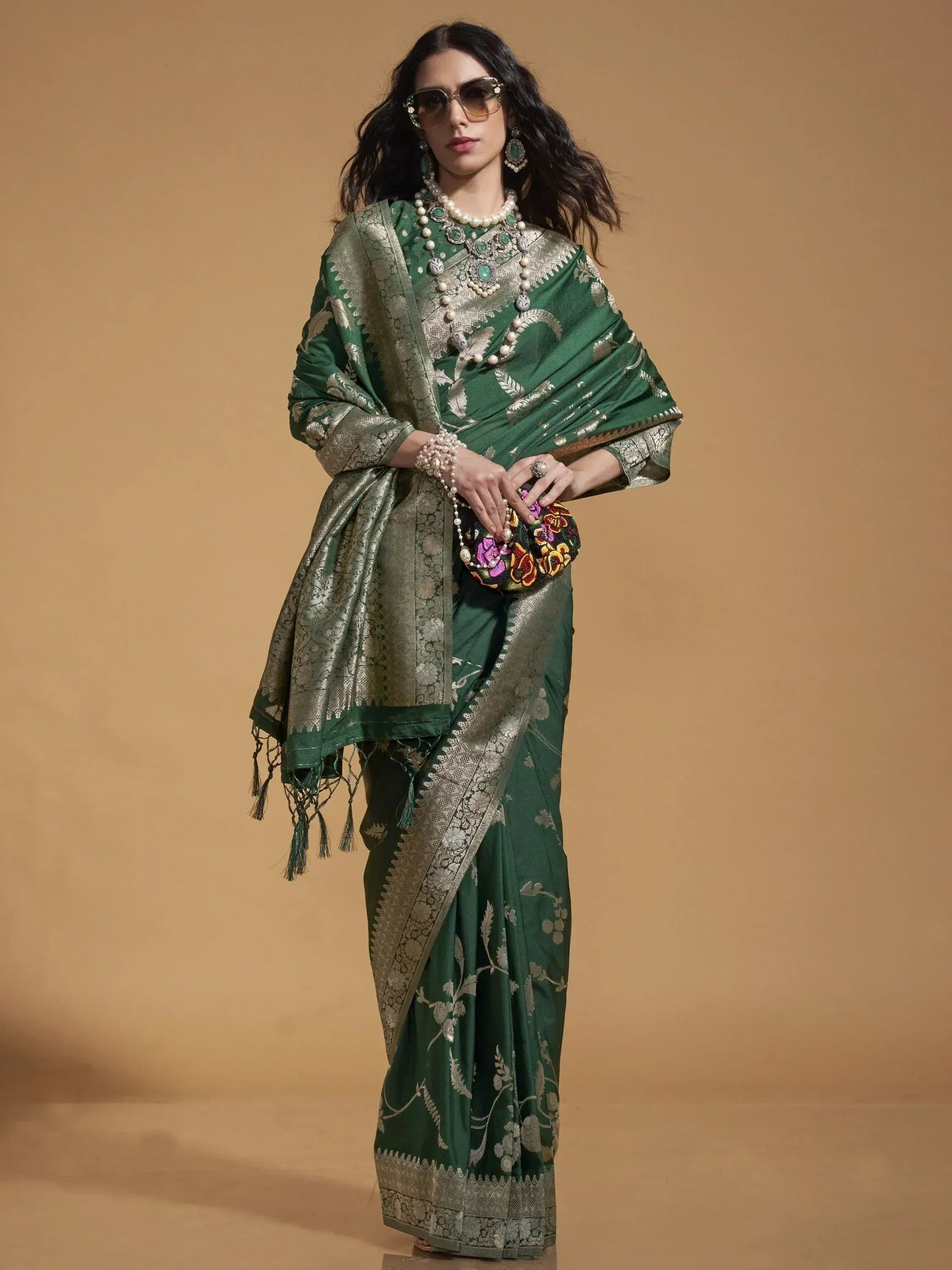 Elegant green designer saree with silver floral embroidery, perfect for Indian ethnic wear occasions.