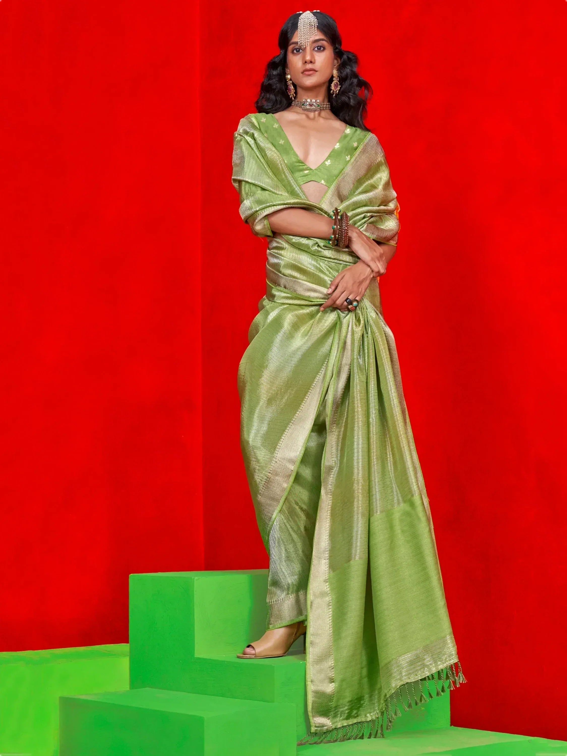 Woman in elegant green silk saree with gold border, traditional Indian ethnic wear, festive occasion attire