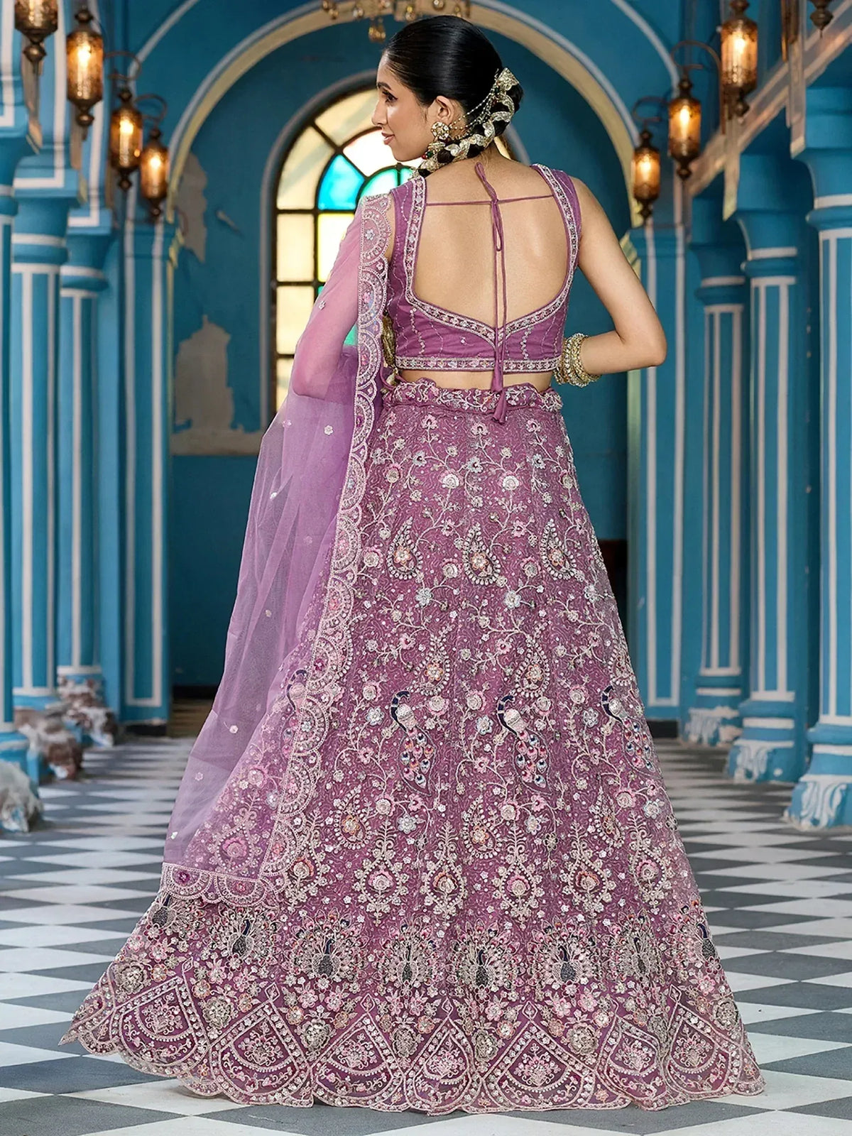 Elegant purple lehenga choli with intricate embroidery and peacock motifs, perfect for Indian ethnic wear.