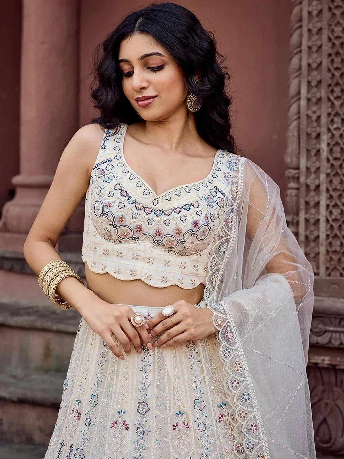 Elegant cream lehenga choli with floral embroidery and sheer dupatta for Indian ethnic wear