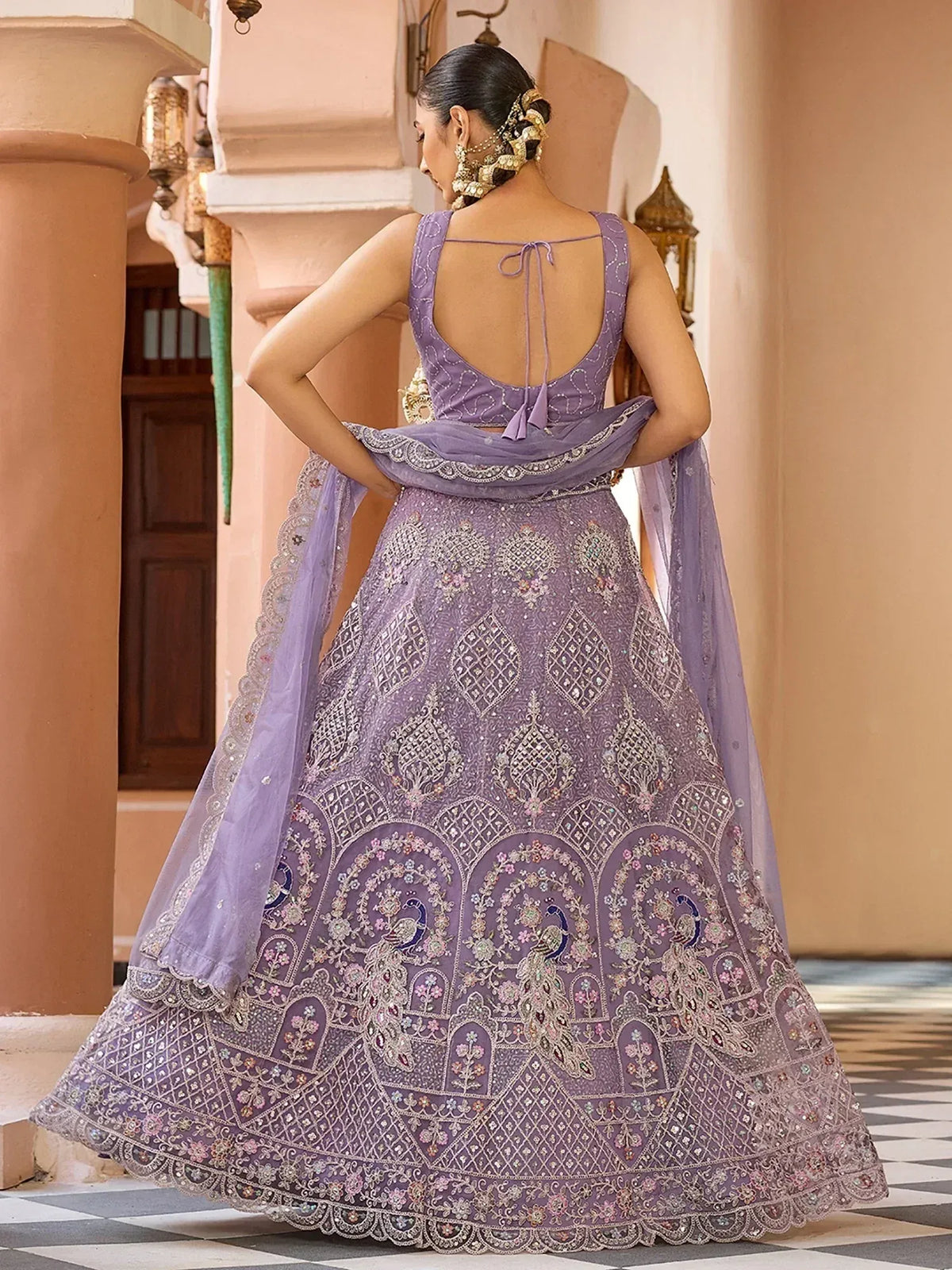 Elegant purple lehenga choli with intricate embroidery and peacock motifs, perfect for Indian ethnic wear.