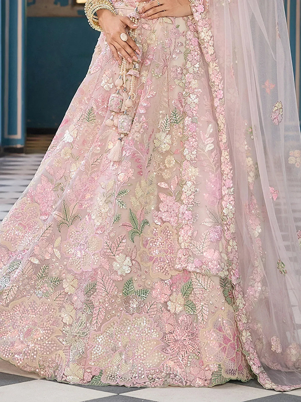 Pink floral embroidered lehenga with intricate detailing and sheer dupatta