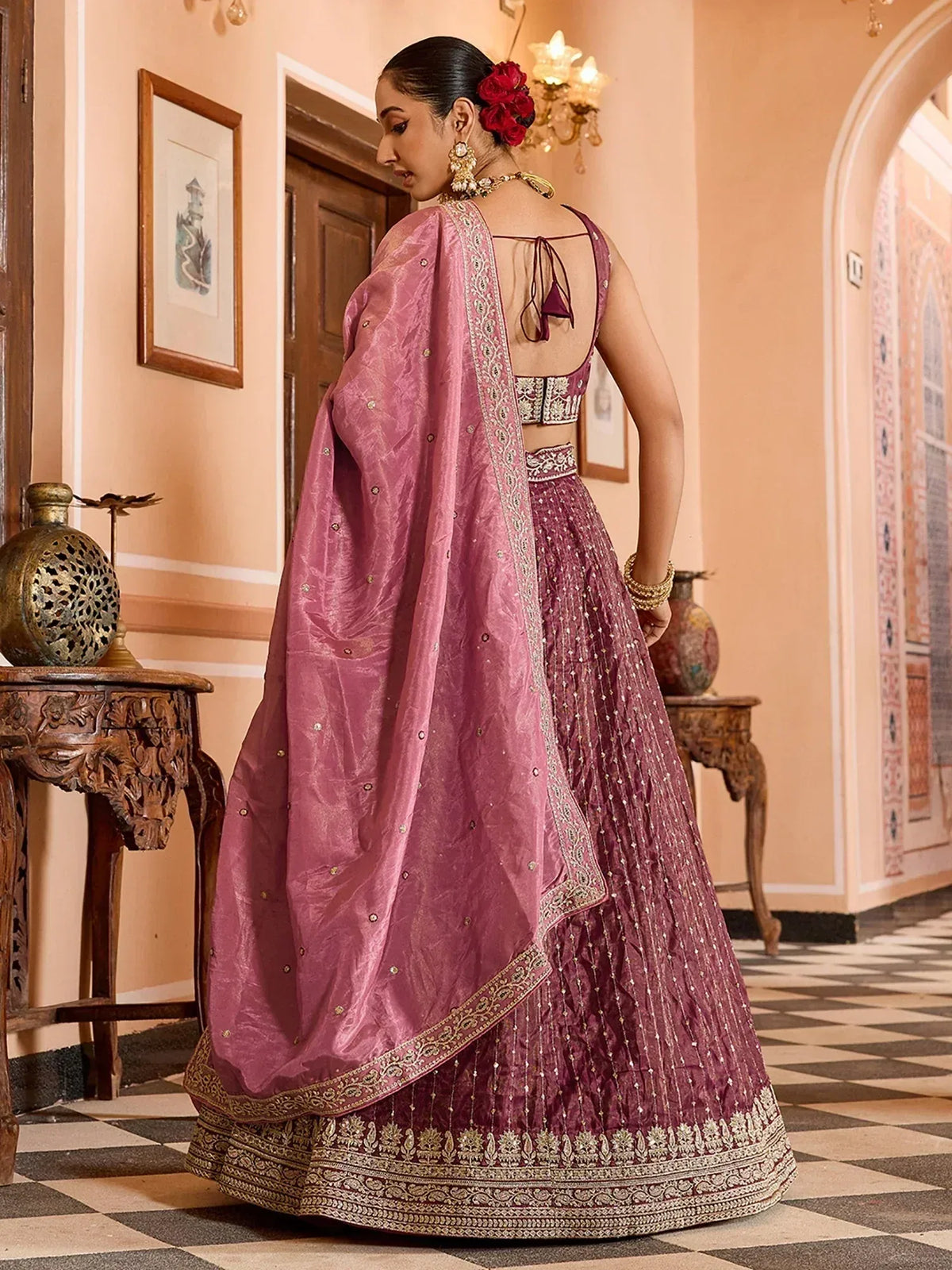 Elegant pink lehenga choli with intricate embroidery and golden detailing, perfect for Indian ethnic wear.