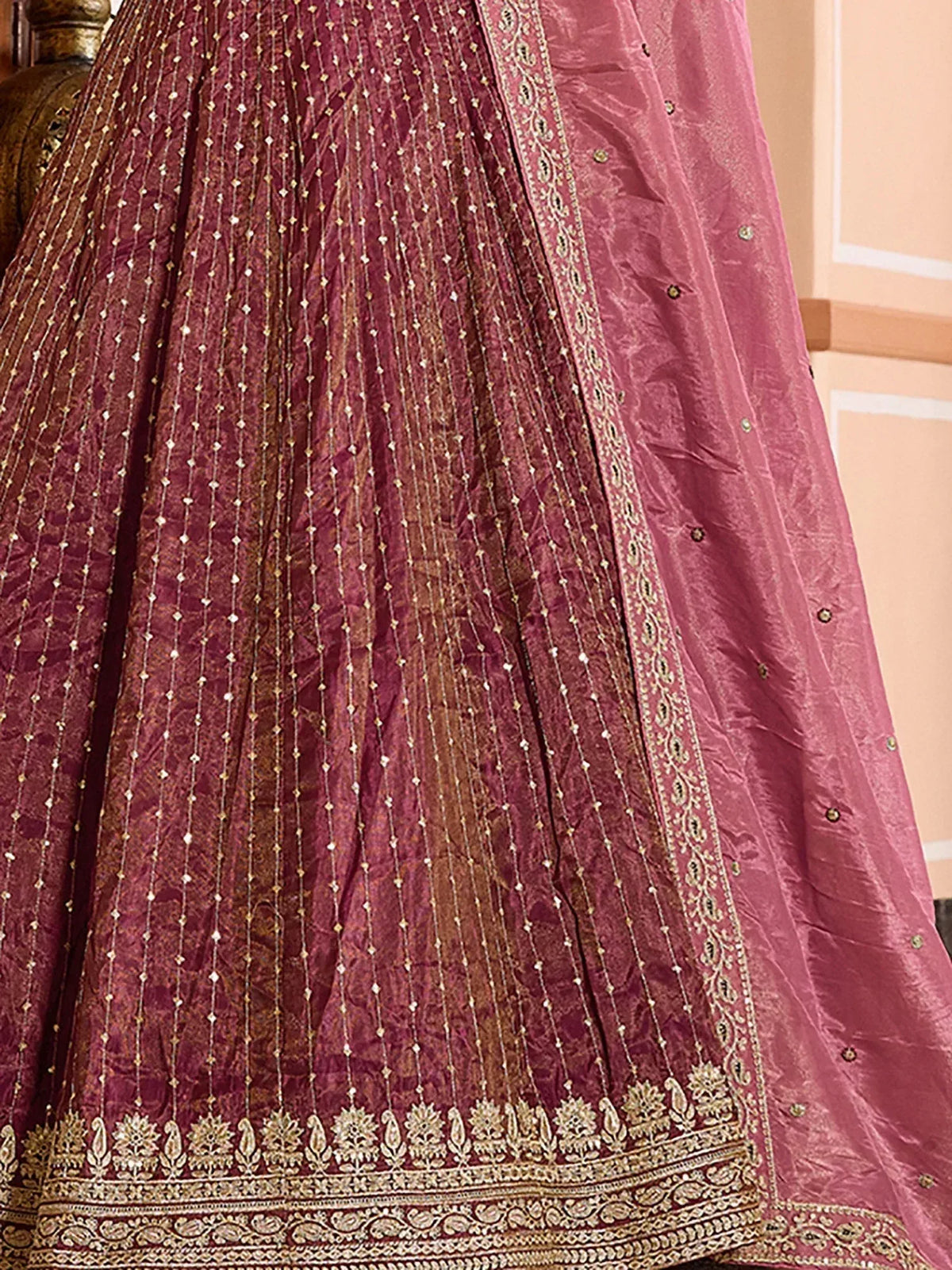 Elegant maroon lehenga with gold embroidery and floral border, perfect for Indian ethnic wear.