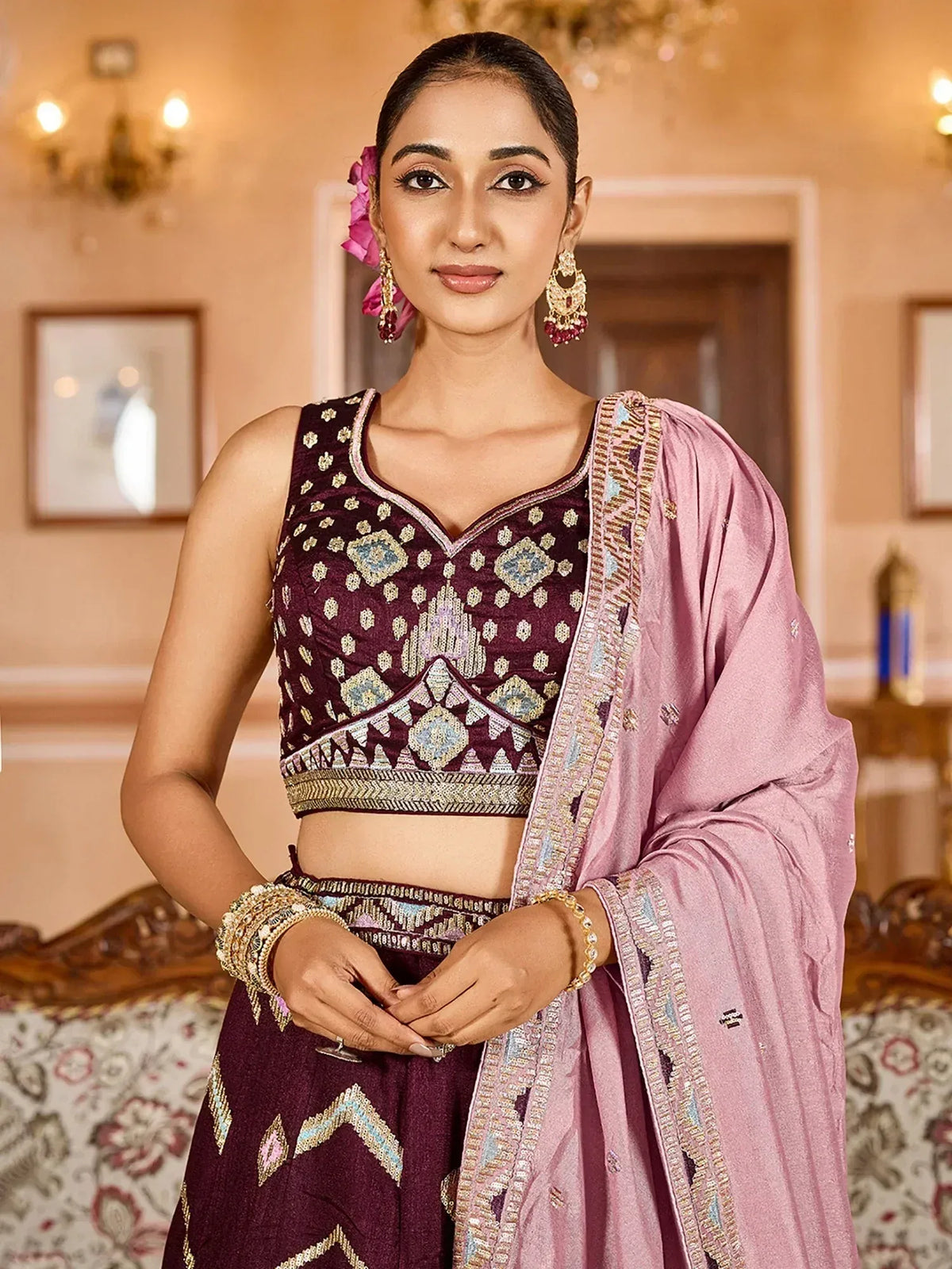 Elegant maroon lehenga choli with intricate embroidery and pink dupatta, perfect for Indian ethnic occasions.