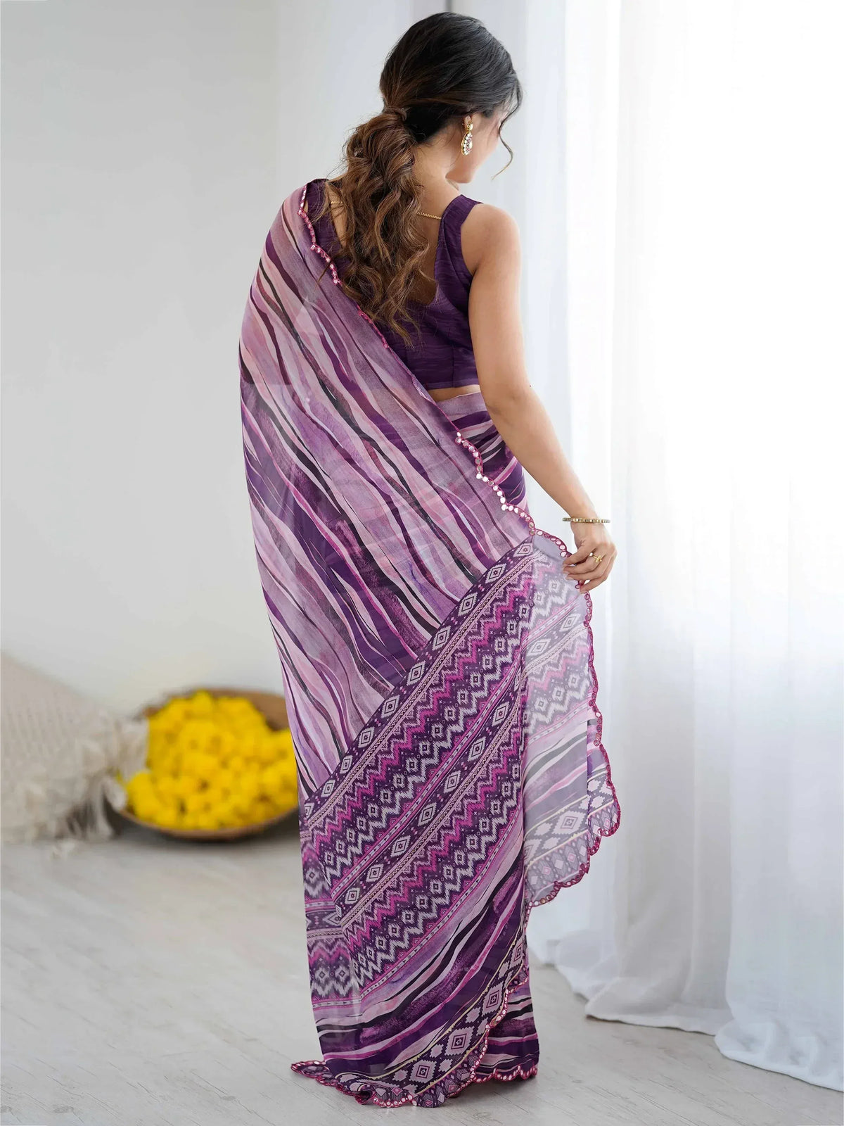 Purple and pink striped saree with geometric border, styled with matching blouse for ethnic wear