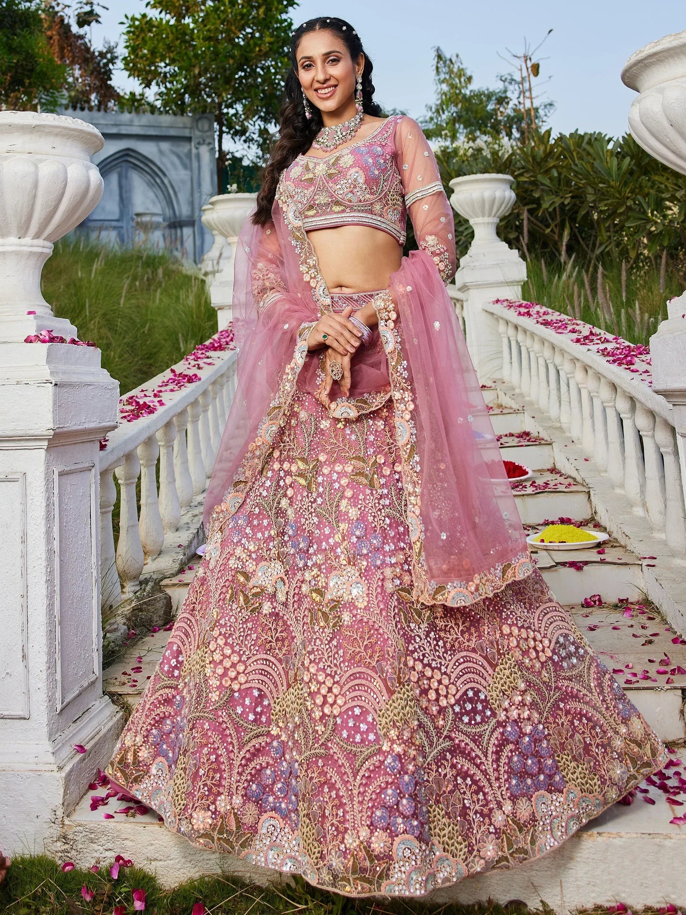 Pink embroidered lehenga choli with floral motifs, perfect for Indian weddings and festive occasions.