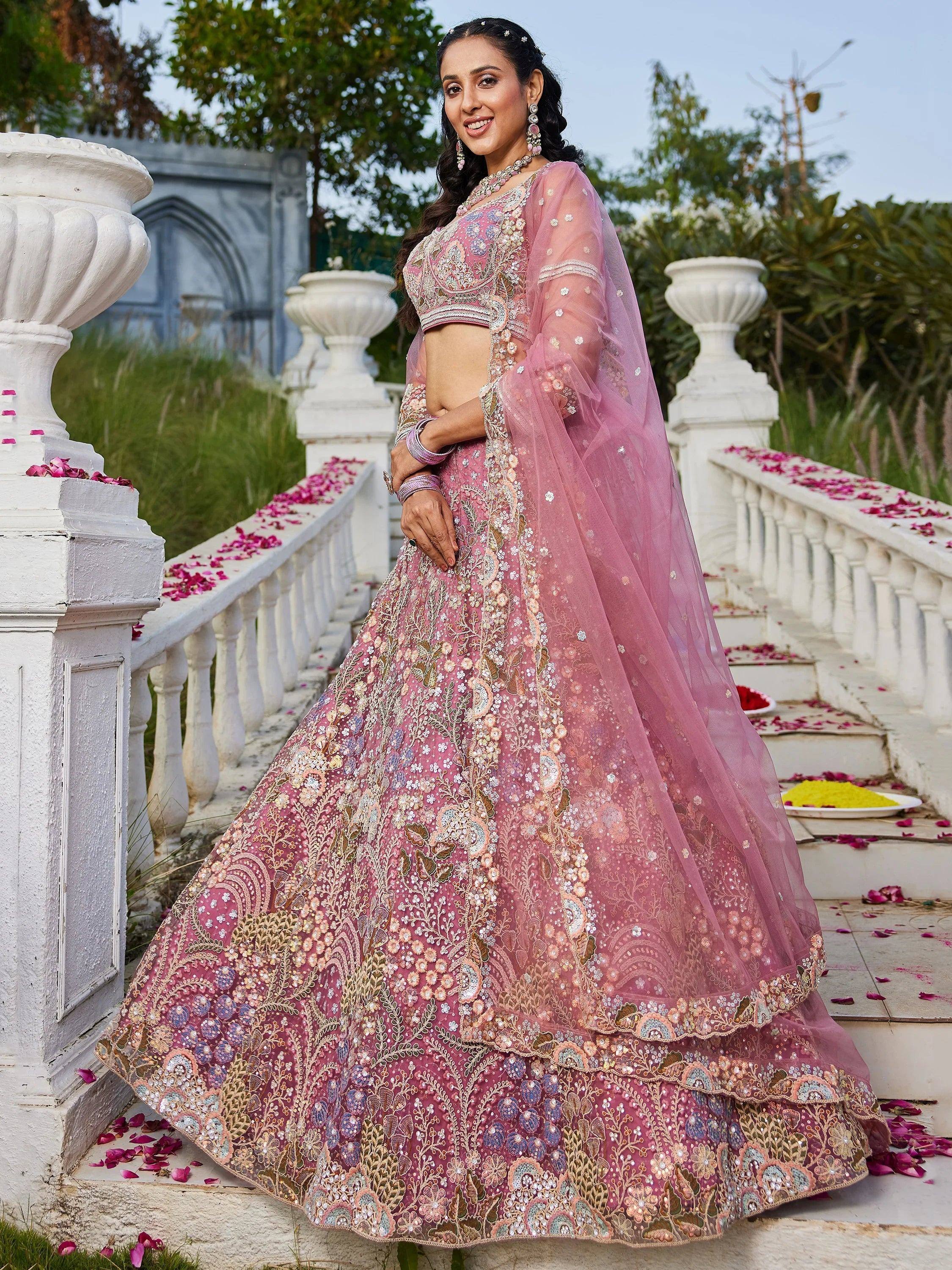 Pink embroidered lehenga choli with floral motifs, perfect for Indian weddings and festive occasions.